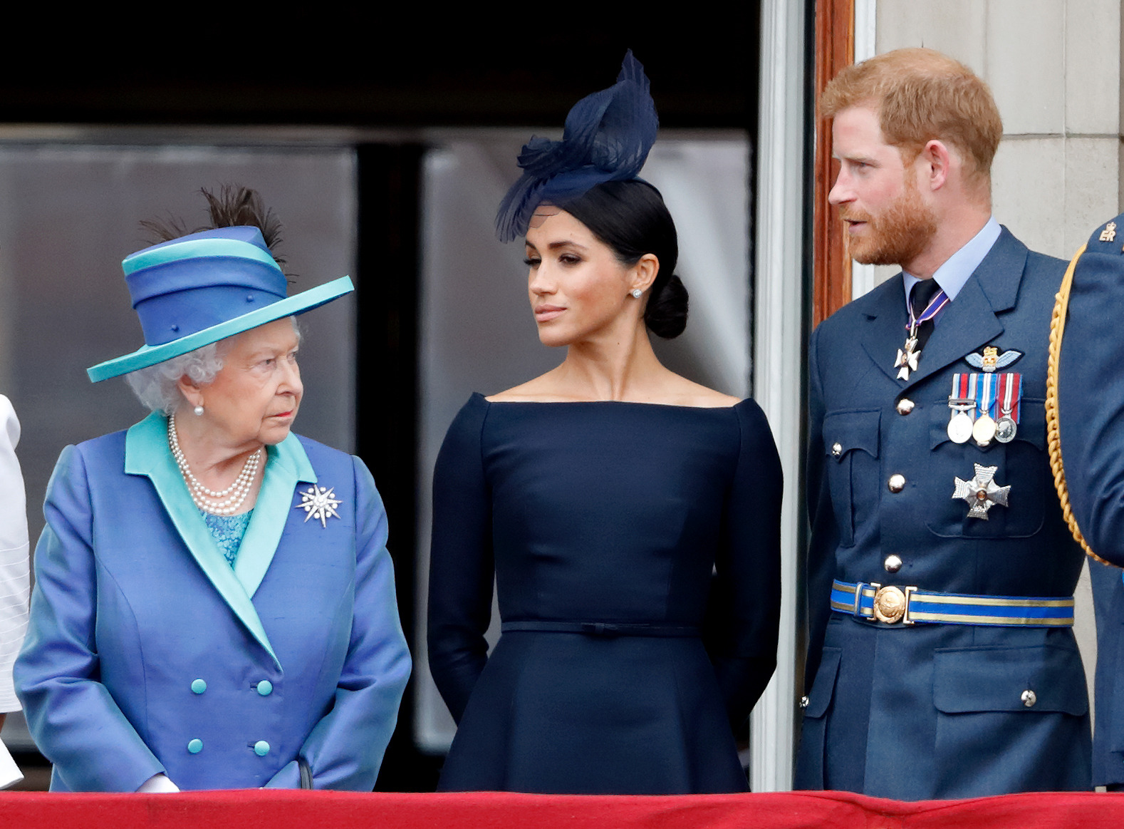 Queen Elizabeth II, Meghan, Duchess of Sussex and Prince Harry watch a flypast to mark the centenary of the Royal Air Force from the balcony of Buckingham Palace on July 10, 2018. Photo / Getty Images