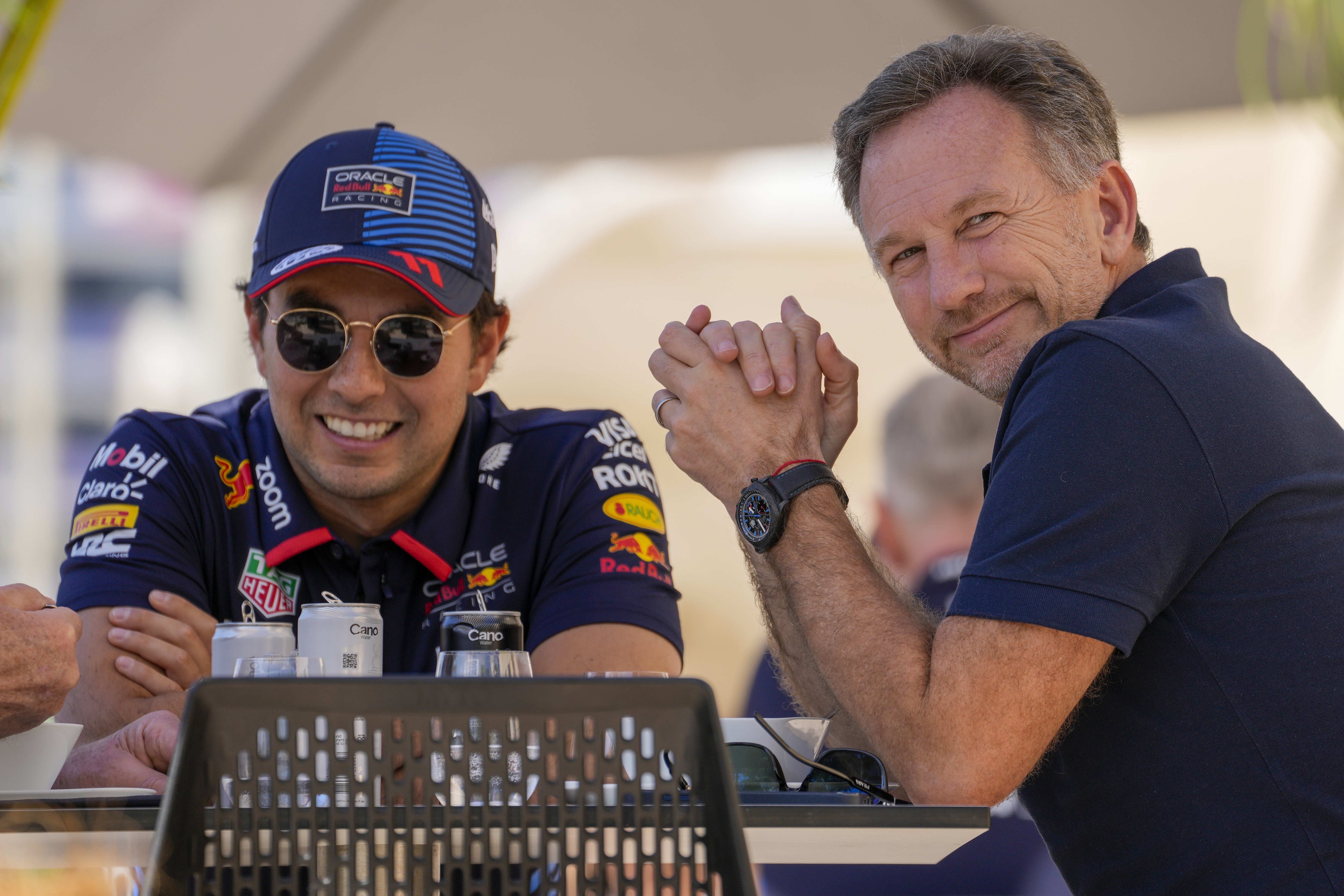 Red Bull team principal Christian Horner, right, chats with Red Bull driver Sergio Perez of Mexico at the pits during Formula One pre season test. Photo / AP