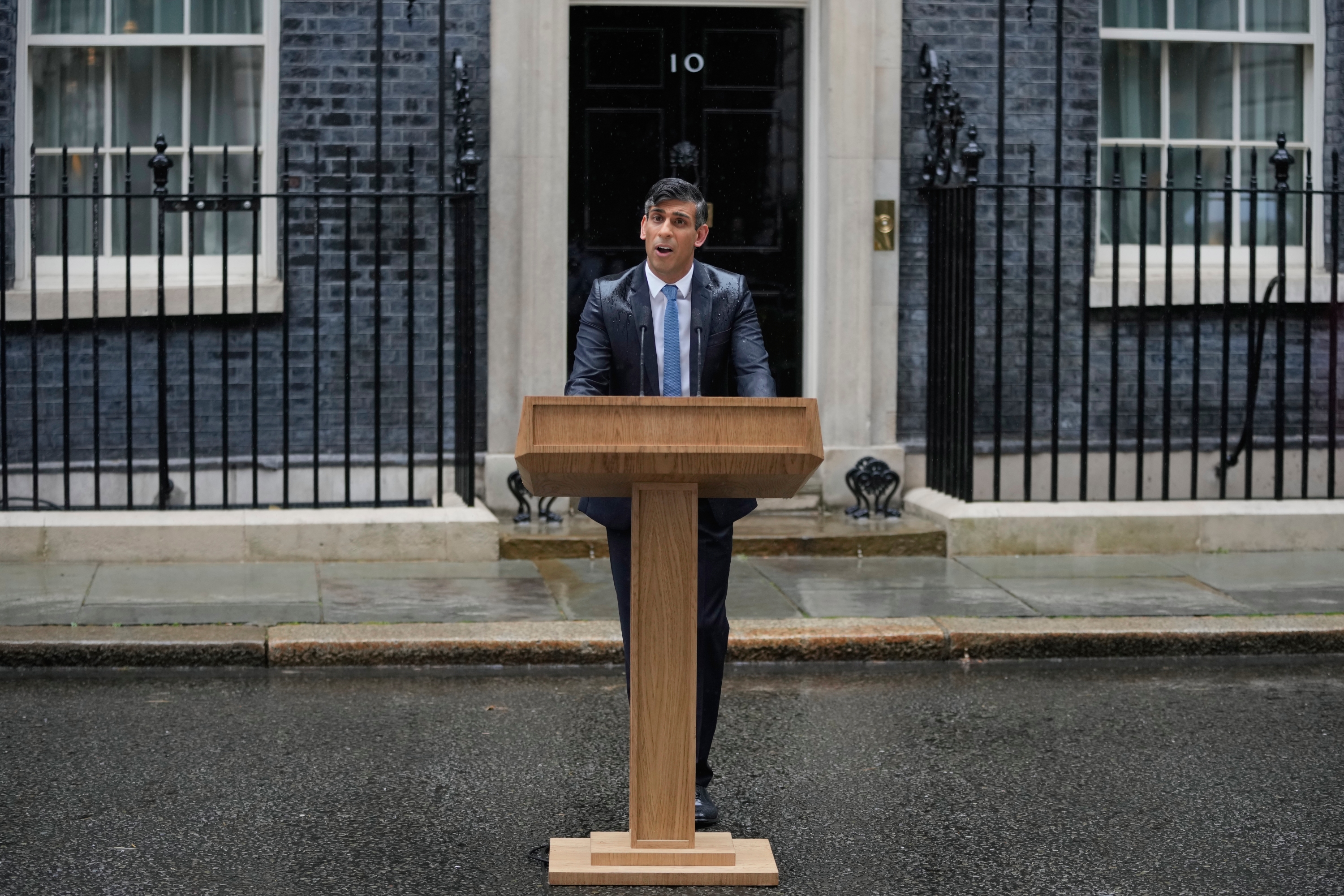 The PM's announcement was nearly drowned out by protesters blasting 'Things Can Only Get Better', a Labour campaign song from the Tony Blair era. Photo / AP
