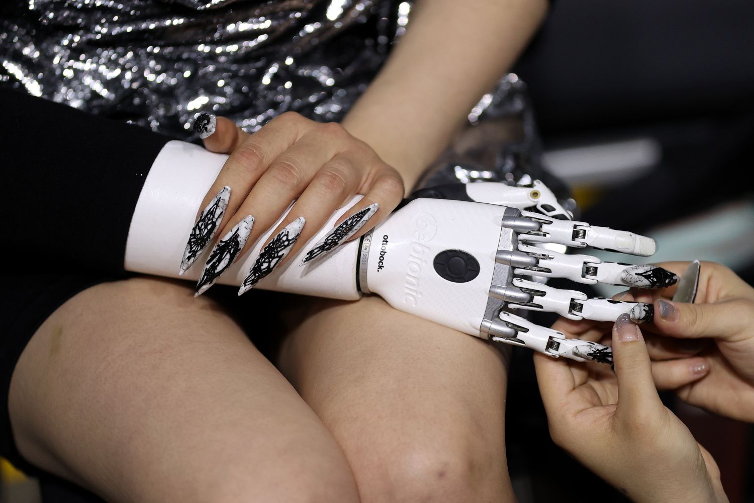 Model Lara having dramatic false nails applied backstage at Cecilia Kang. Photo / Getty Images