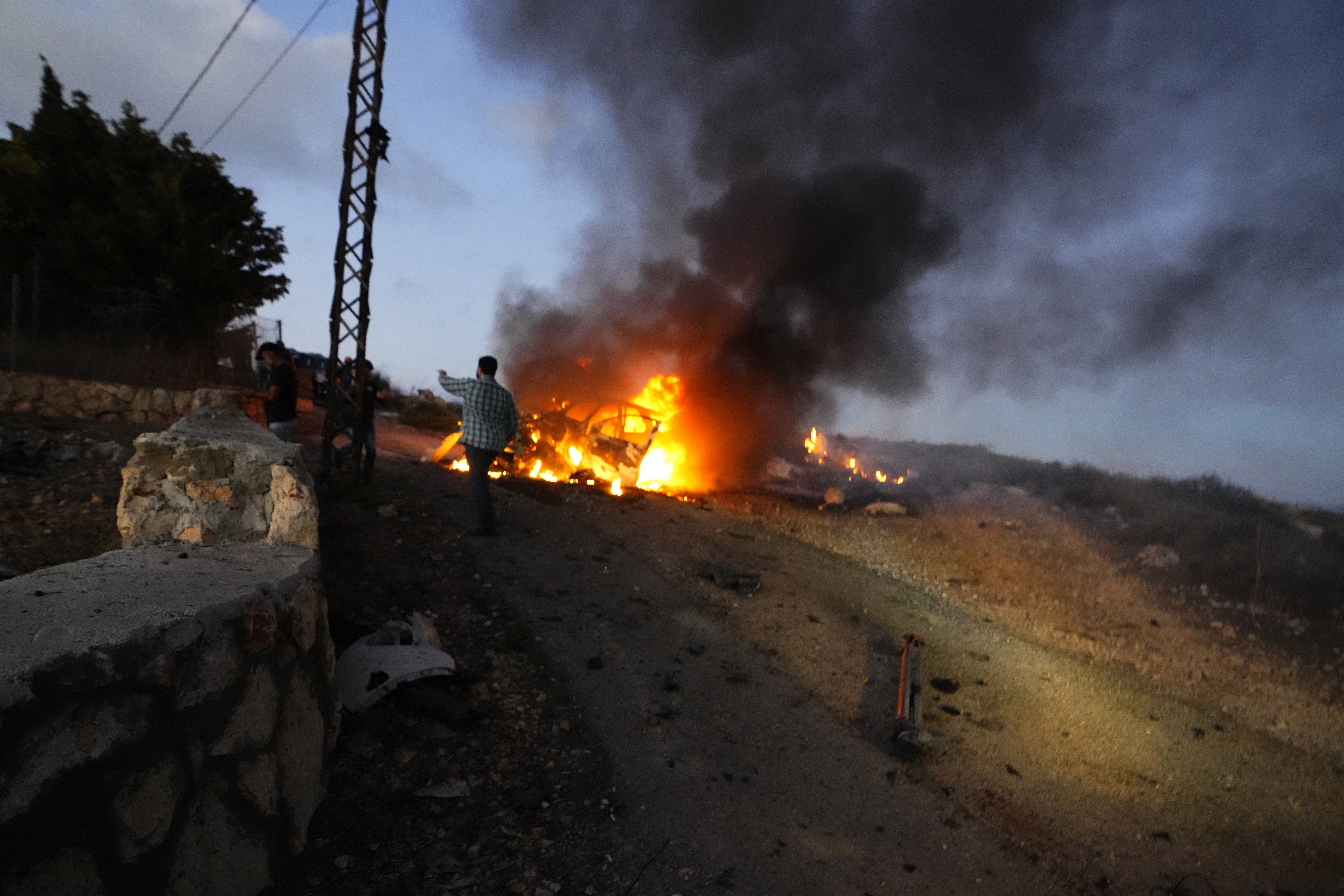 A journalist's car burns after it was hit by Israeli shelling in the Alma al-Shaab border village with Israel in south Lebanon. Photo / AP