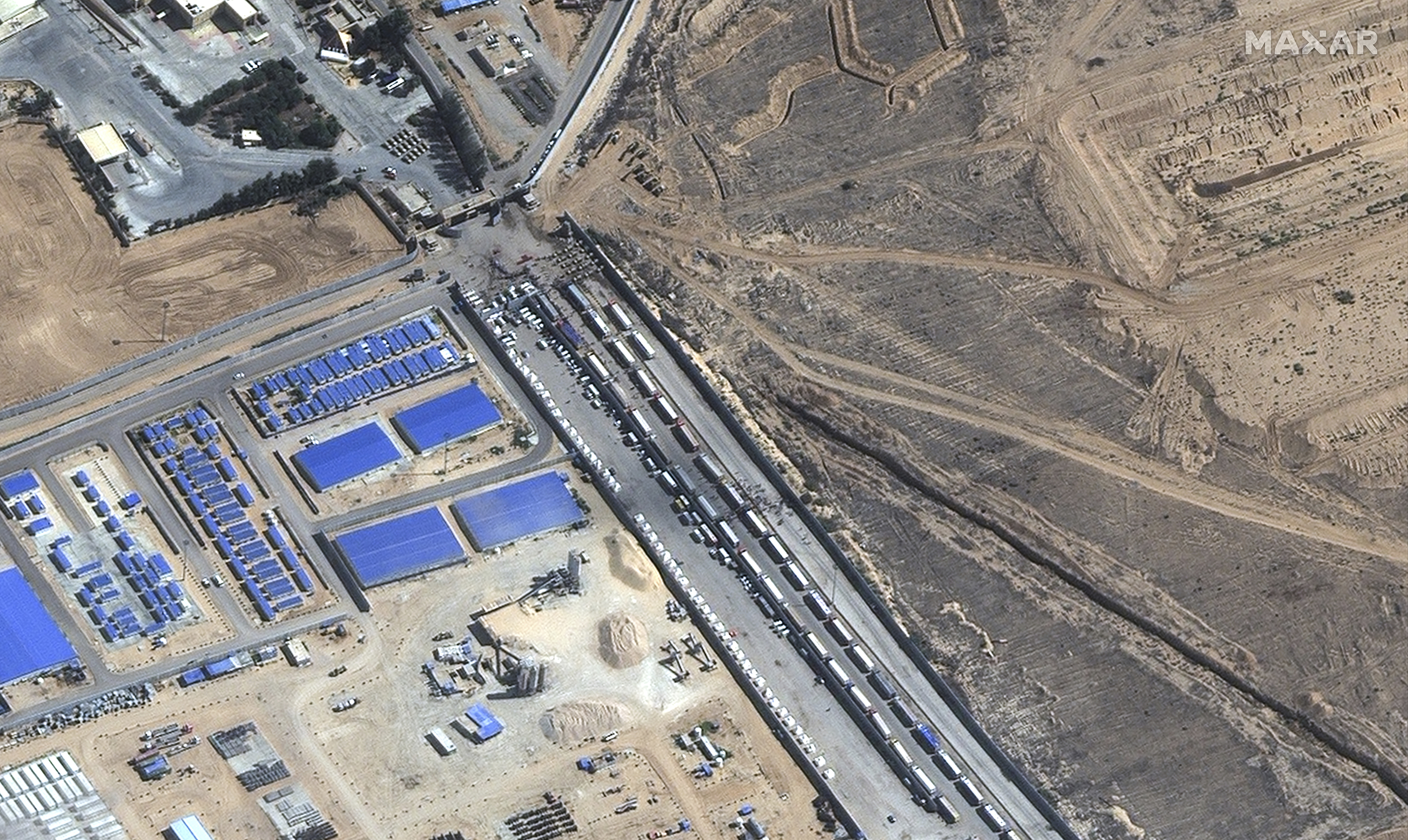 Aid trucks wait on the Egyptian side of the Rafah border crossing. Photo / AP