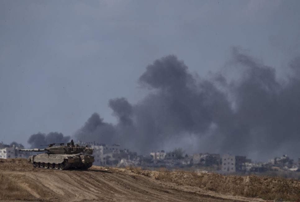 After an explosion in the Gaza Strip, an Israeli tank stands near the Israel-Gaza border. Photo / AP