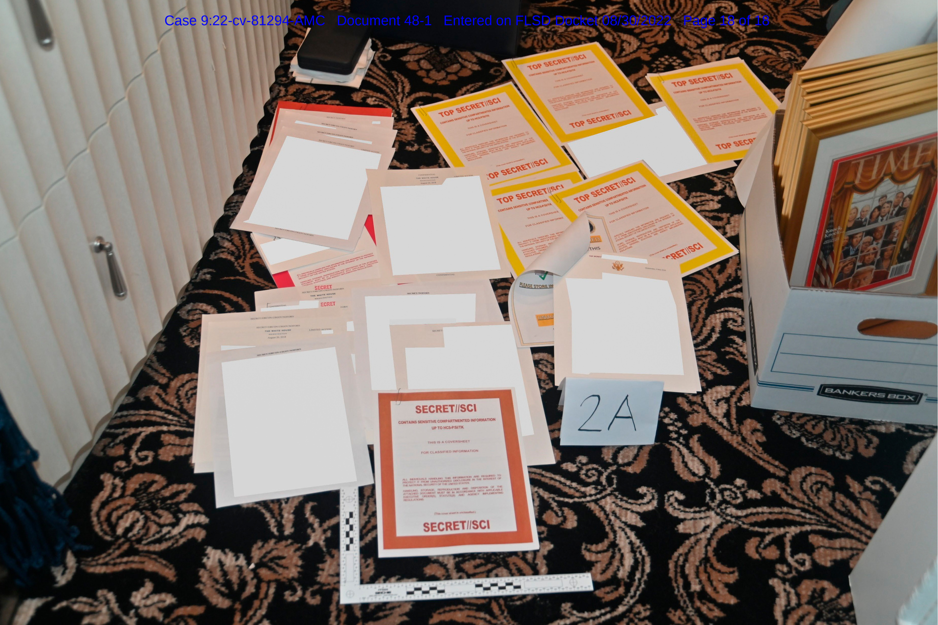 This image contained in a court filing by the Department of Justice and redacted by in part by the FBI, shows a photo of documents seized during the search of Trump's Mar-a-Lago estate. Photo / AP