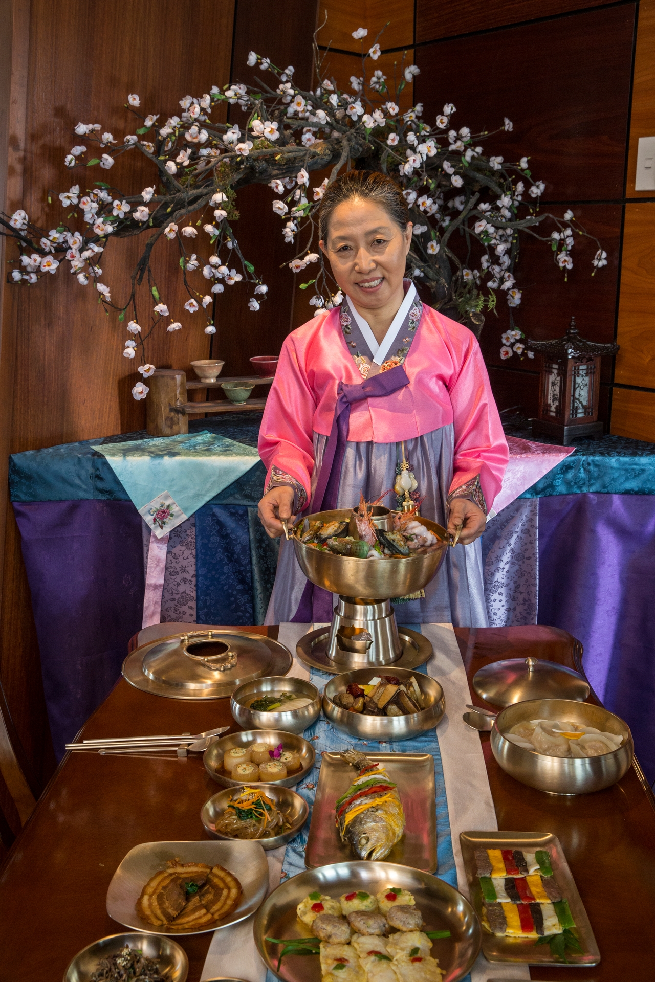 Jin Kyung Youn with some of the dishes at Jami Restaurant, Wairau Valley. Photo / Peter Meecham