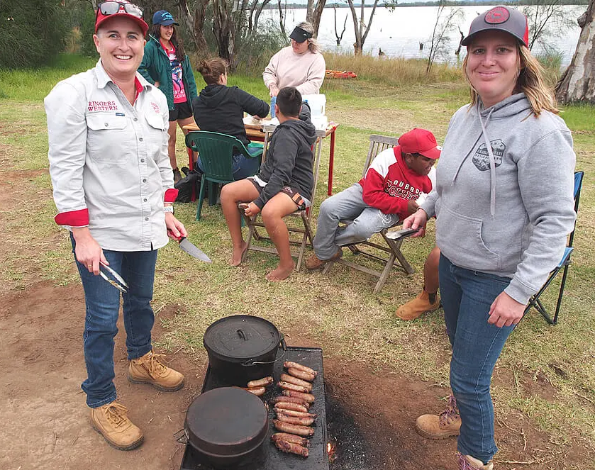 Lana Masterson (right) cooking for the DTT kids after an activity at Lake Cargelligo. Photo / DTT