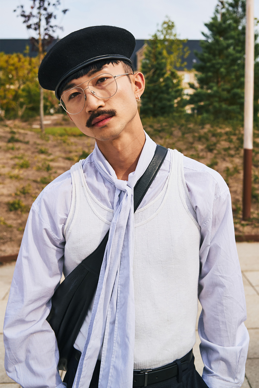 Layered tank tops worn over a tie-neck shirt. Photo / Simbarashe for The New York Times