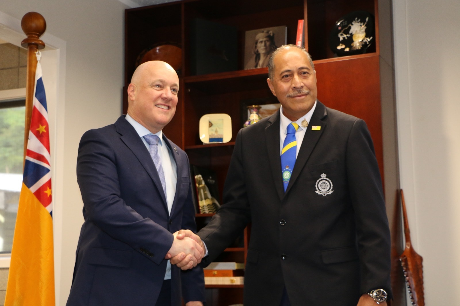 Prime Minister Christopher Luxon and Niue Premier Dalton Tagelagi shake hands ahead of their bilateral meeting. Photo / Pool