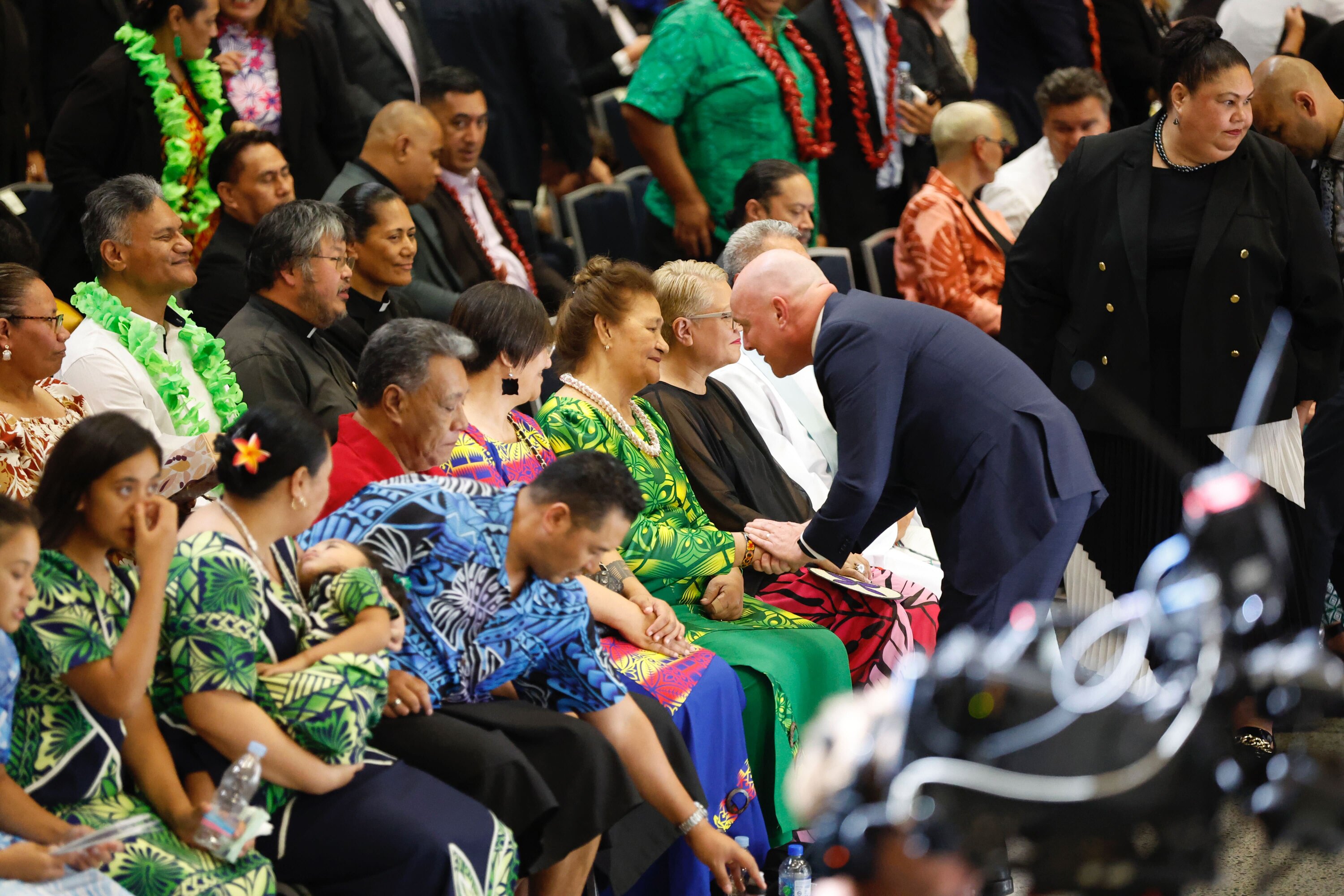 Collins' mother is greeted by Prime Minister Christopher Luxon at today's memorial service. Photo / Michael Craig