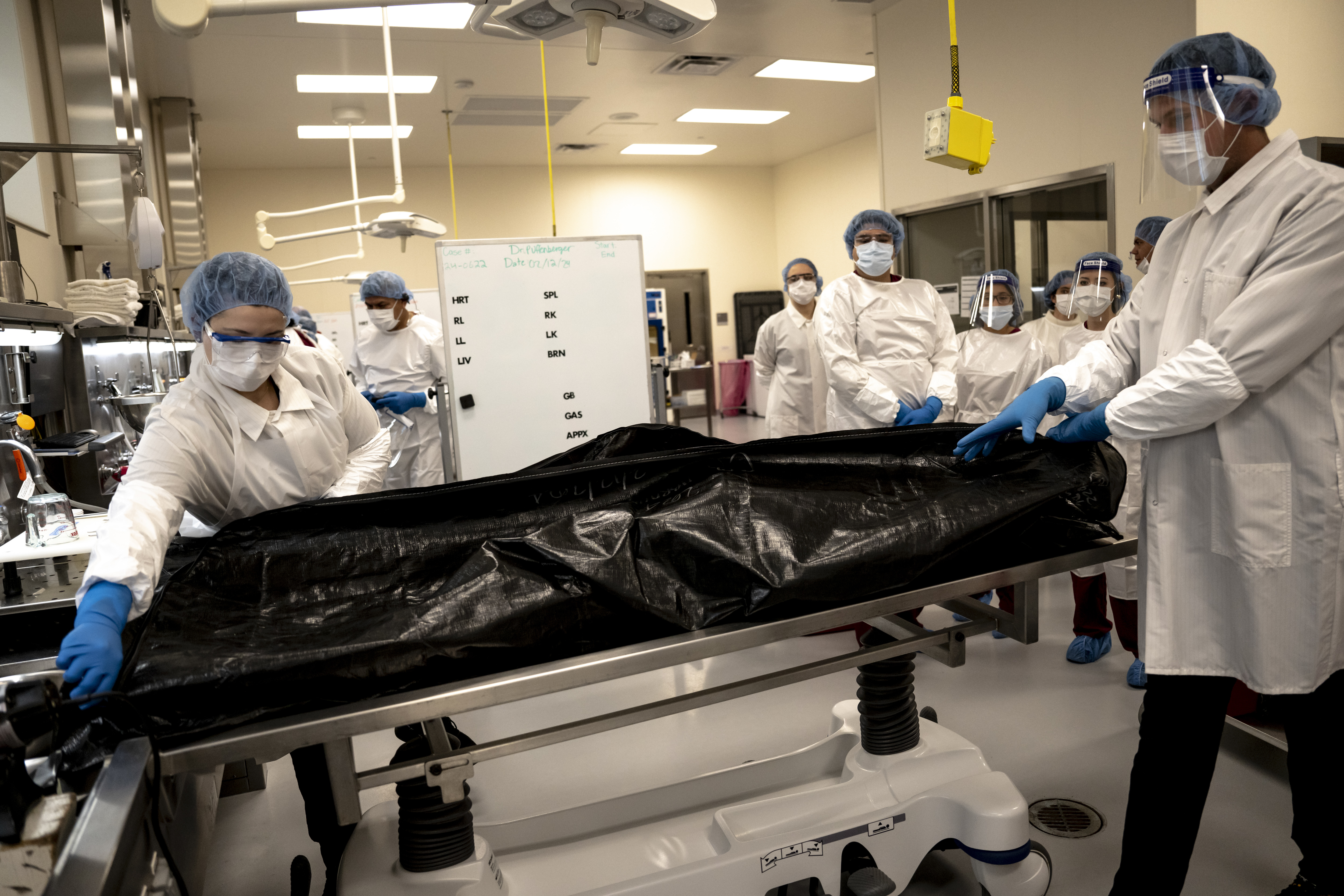 Workers at the Denver Office of the Medical Examiner prepare to autopsy the body of a person who died of an overdose on February 12, 2024. Photo / Meridith Kohut, The New York Times