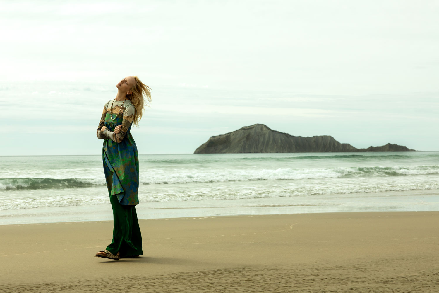 Lili takes in the fresh air at Waimarama Beach wearing Paloma Wool top, Penny Sage dress, Juliette Hogan trousers, Birkenstock sandals and necklace stylist's own. Photo / Guy Coombes