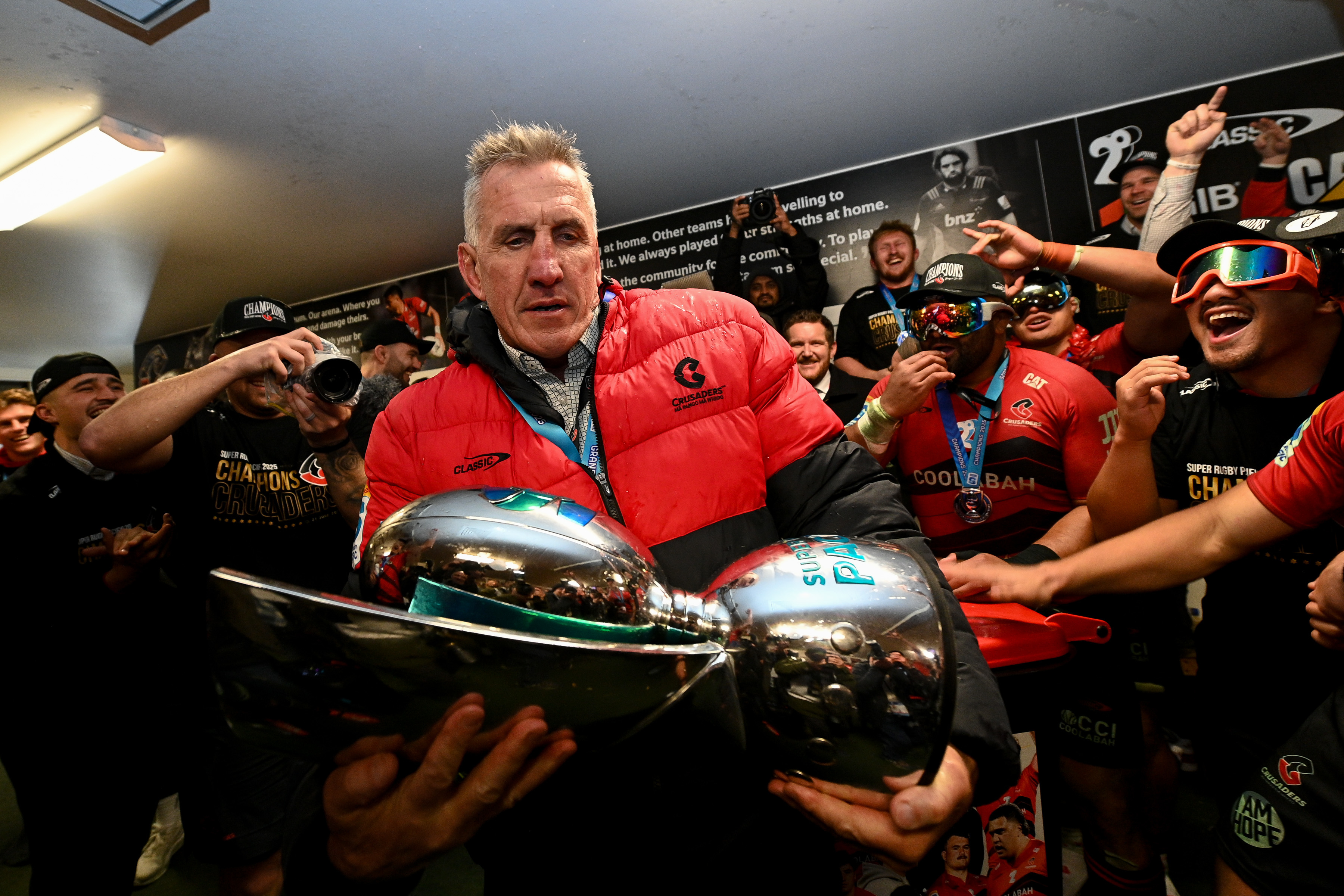 Crusaders coach Rob Penney contemplates the silverware. Photo / Photosport