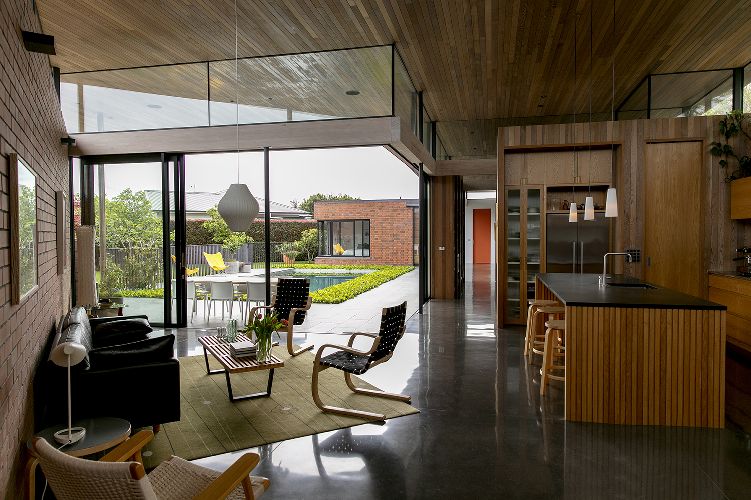 The L-shaped home wraps around an interior courtyard. Photo / Babiche Martens