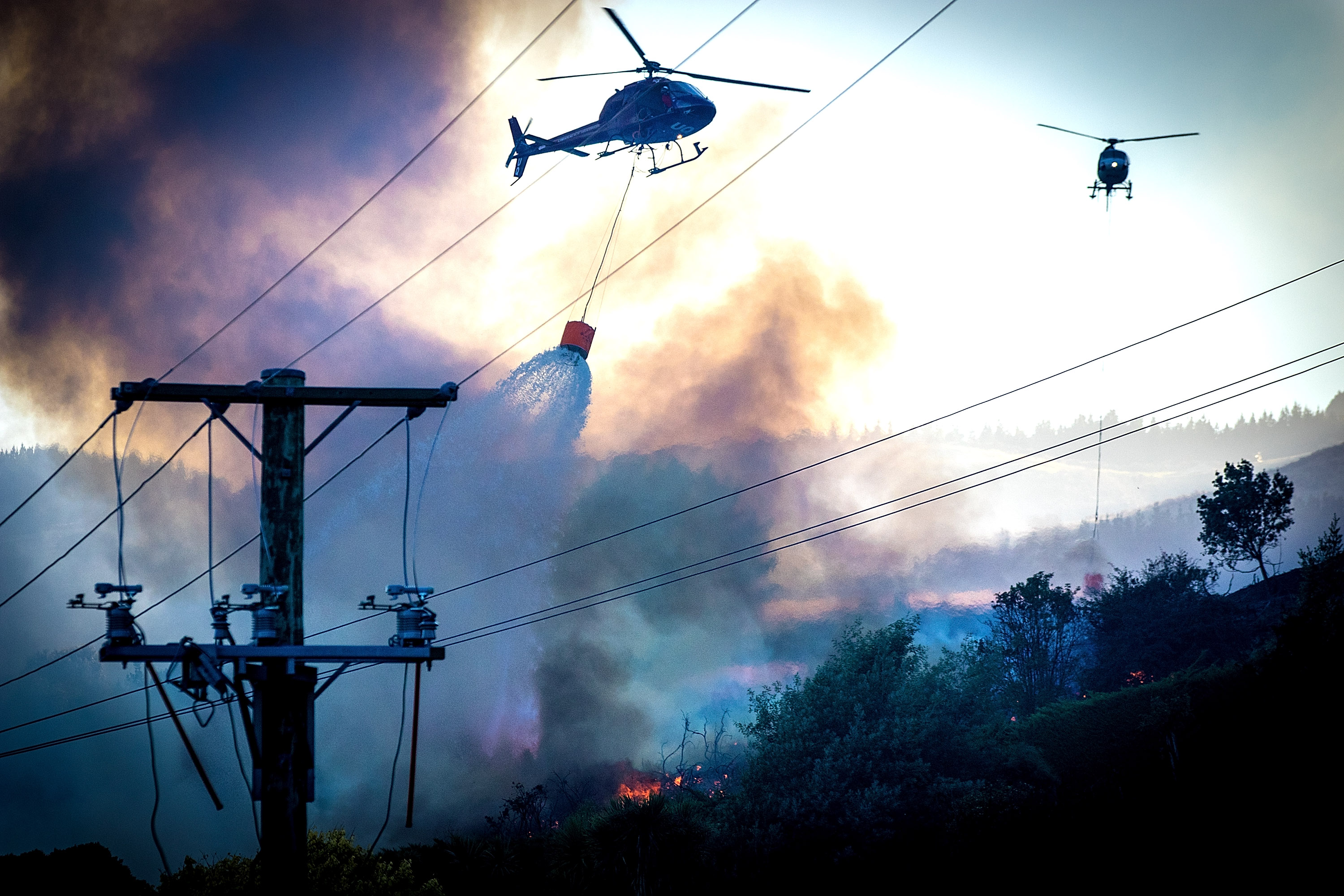 Firefighters and helicopters fighting the 2017 Port Hills fire around Osterholts Road, Tai Tapu. Photo / Christchurch Star
