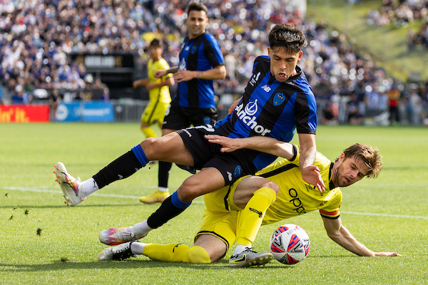 Auckland FC forward Logan Rogerson battles it out with Wellington Phoenix captain Alex Rufer in December. Photo / Photosport
