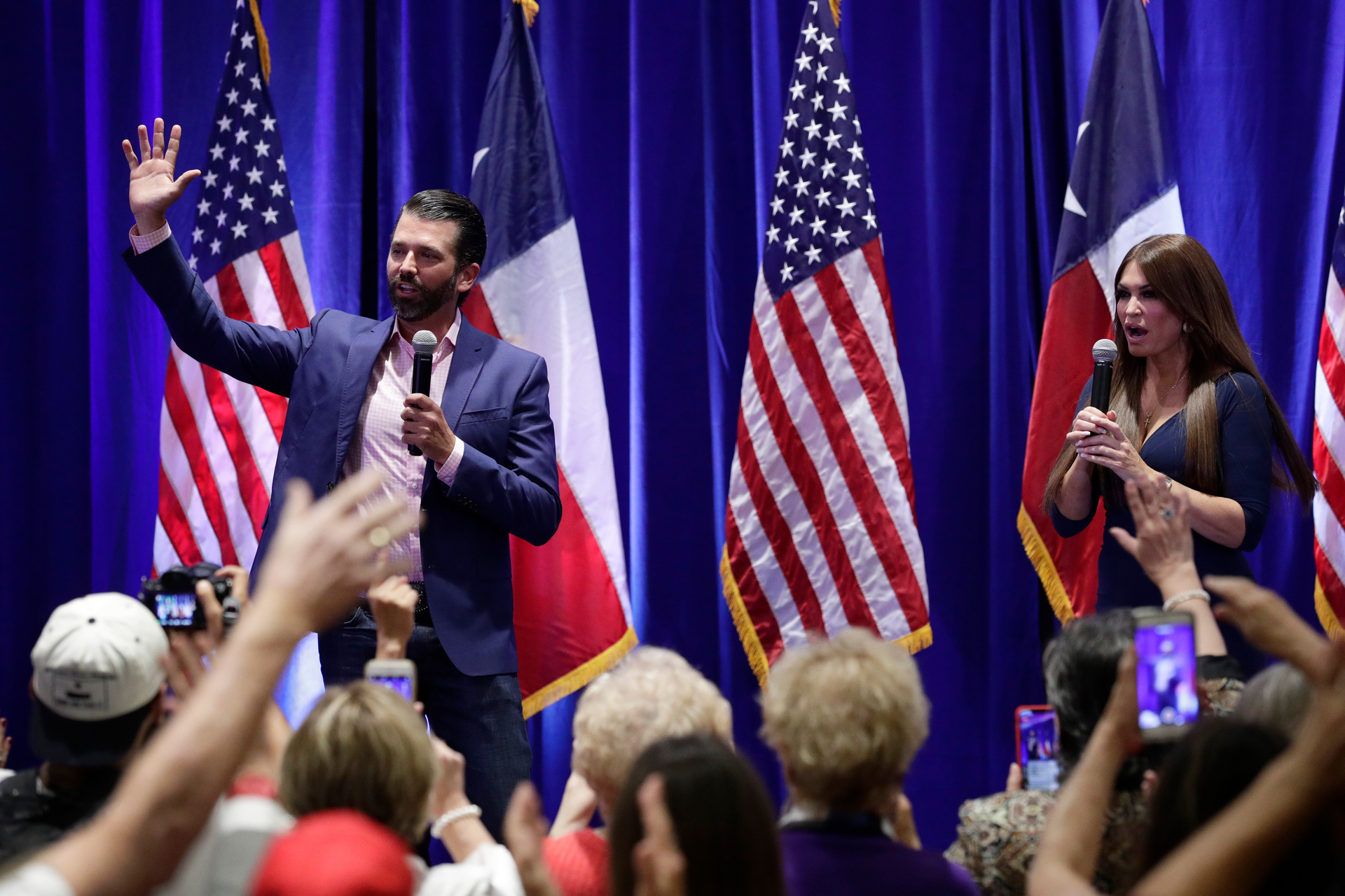 Donald Trump, Jr., left, and Trump campaign senior adviser Kimberly Guilfoyle, right, speak to supporters of President Donald Trump during a panel discussion. Photo / AP