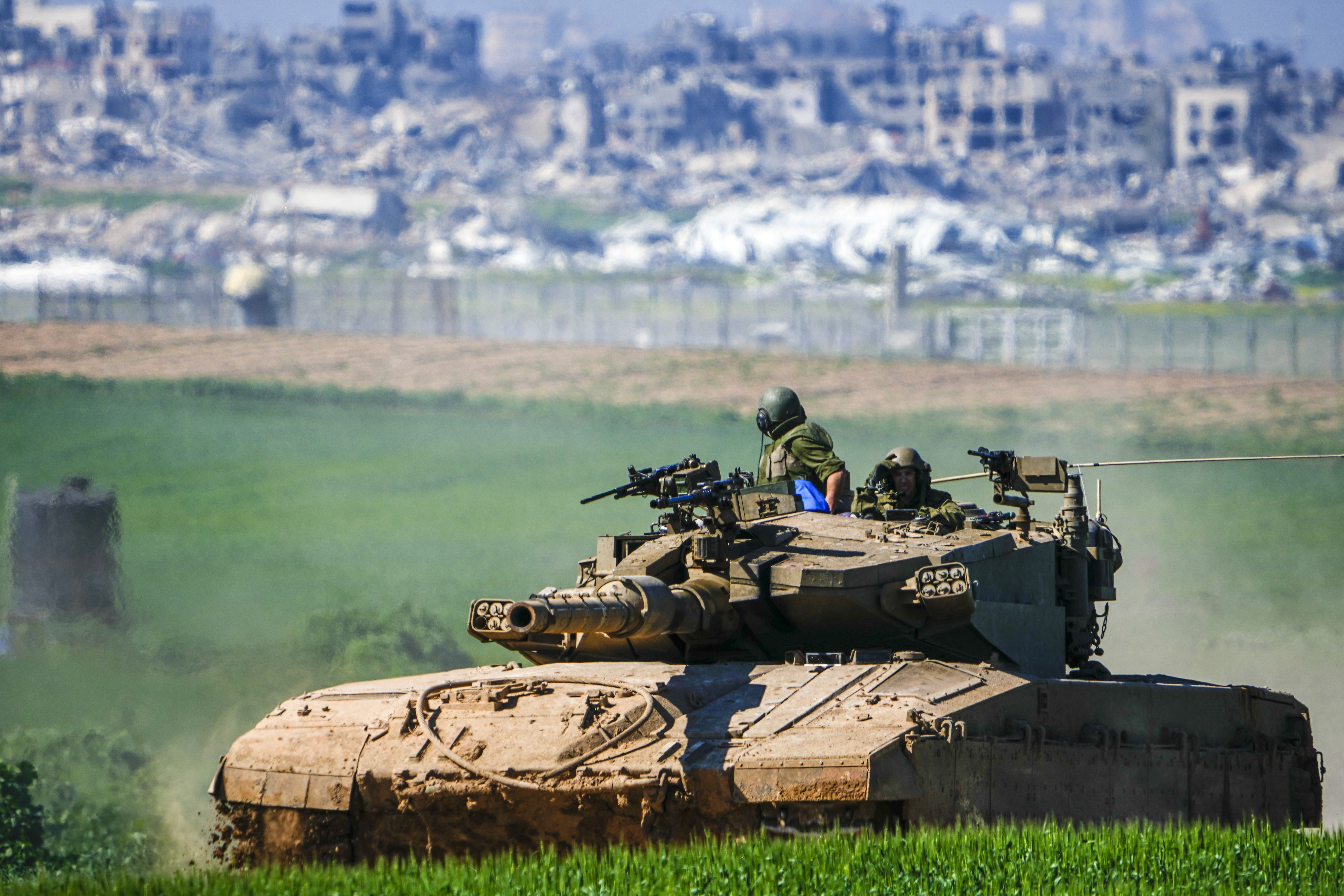Israeli soldiers drive a tank on the border with the Gaza Strip, as seen in southern Israel. Photo / AP