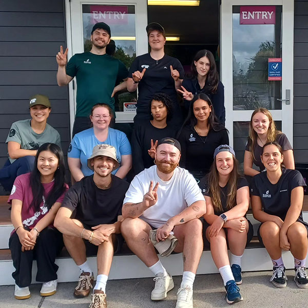 Sam Smith and Christian Cowan front and centre with staff at Rotorua Canopy Tours. Photo / Rotorua Canopy Tours