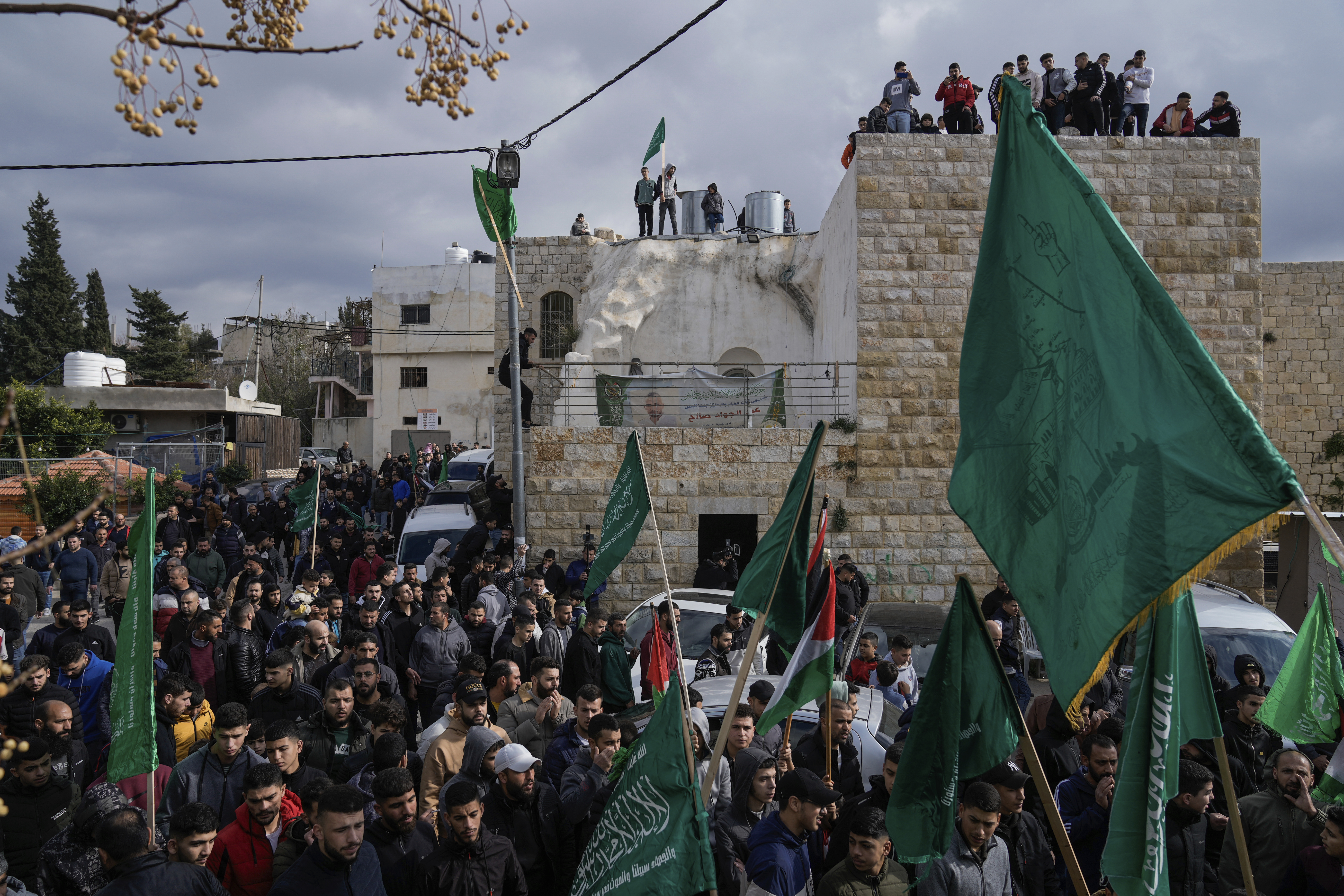 In the West Bank town of Arura, Palestinian demonstrators wave Hamas and their national flags during a protest against the killing of top Hamas official Saleh Arouri in Beirut. Photo / AP