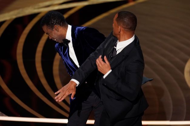 Will Smith hits presenter Chris Rock on stage at last year's Oscars ceremony in Los Angeles. Photo / AP