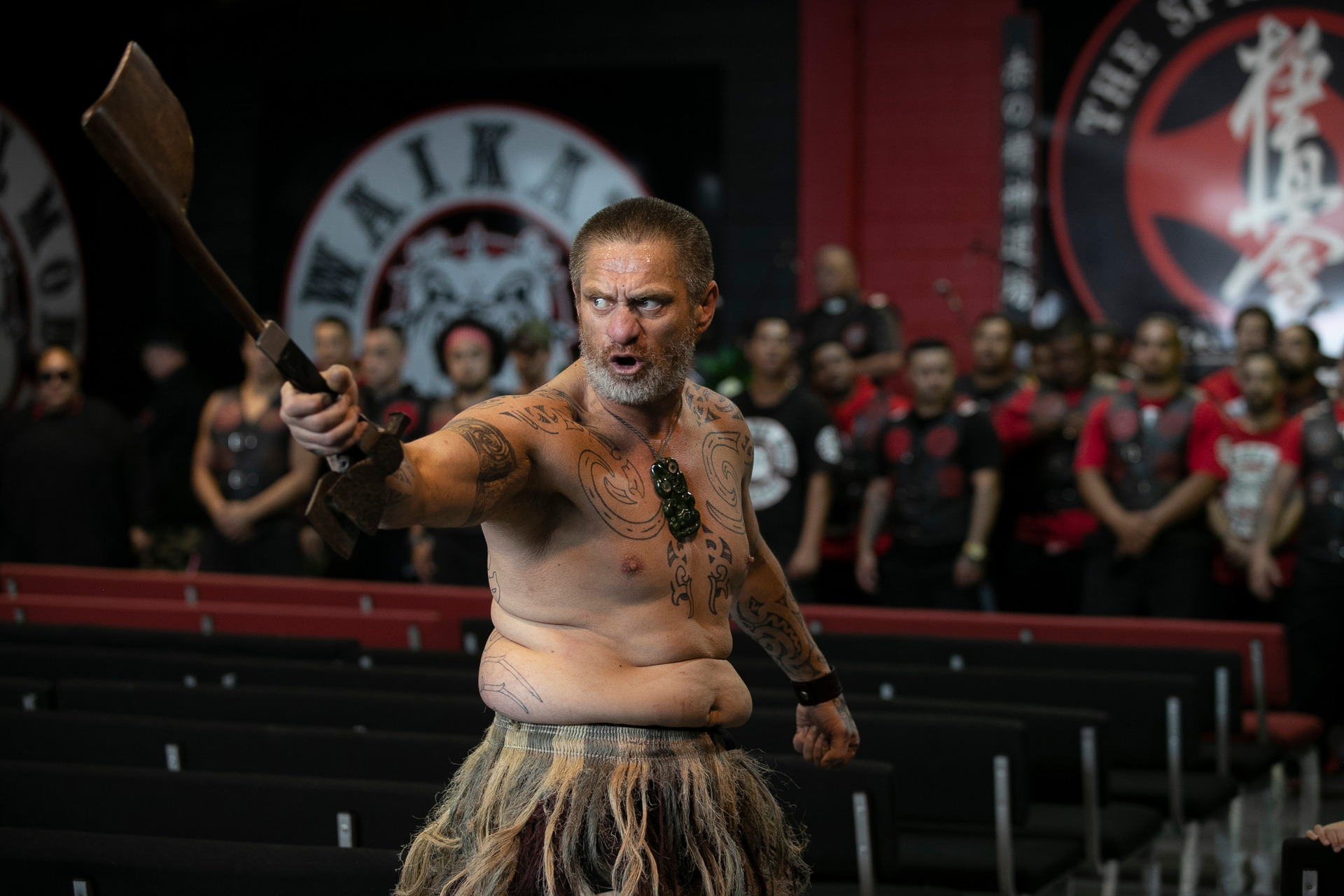 A member of the Waikato Mongrel Mob lays down the challenge as guests are welcomed into the gang's headquaters for a hui in Hamilton. New Zealand Herald photograph/Alan Gibson