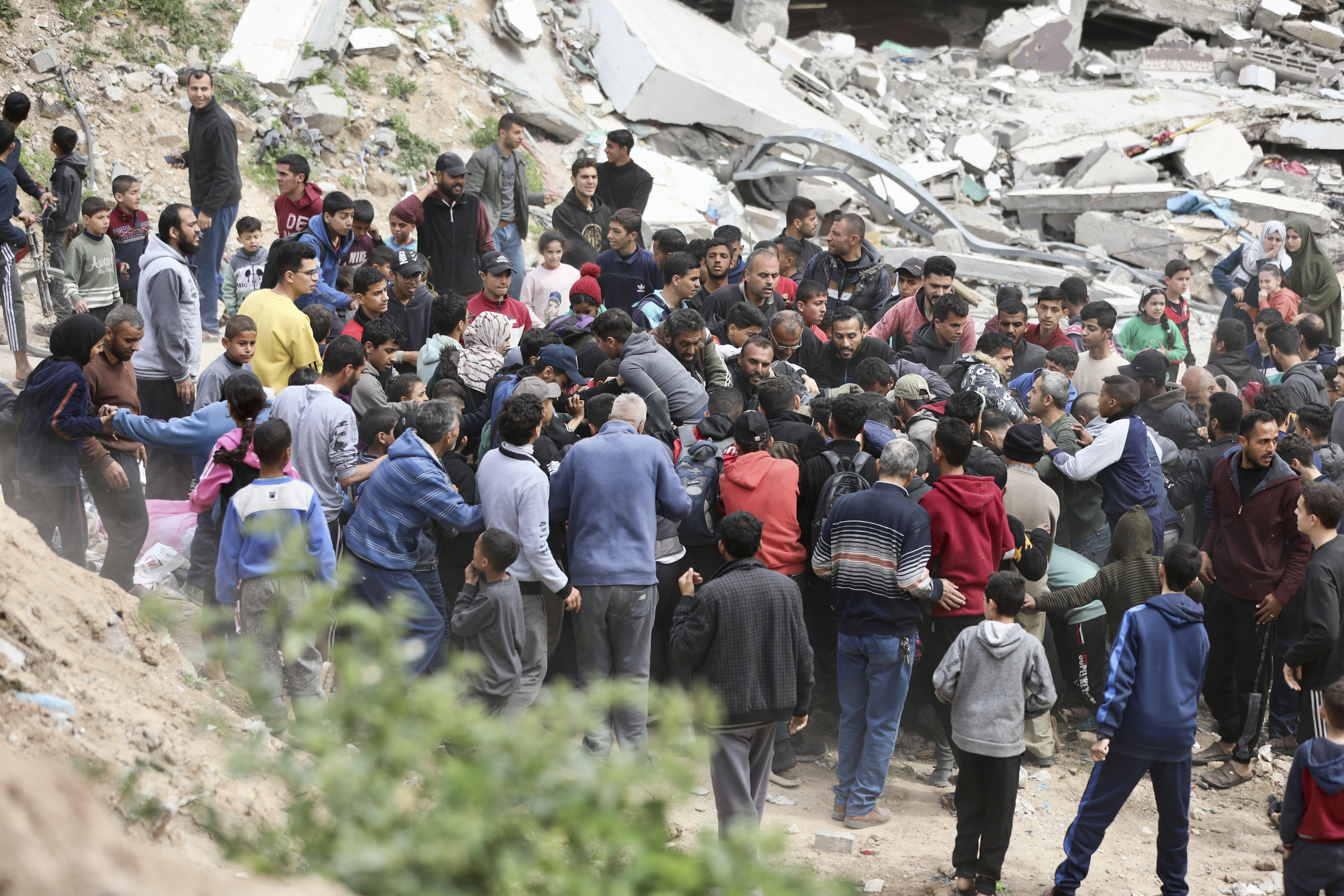 Palestinians rush to collect the humanitarian aid airdropped into Gaza City, Gaza Strip. Photo / AP