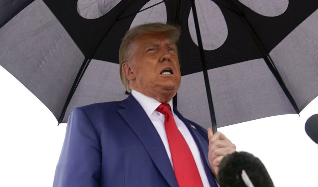 Donald Trump speaks before he boards his plane at Ronald Reagan Washington National Airport. Photo / AP