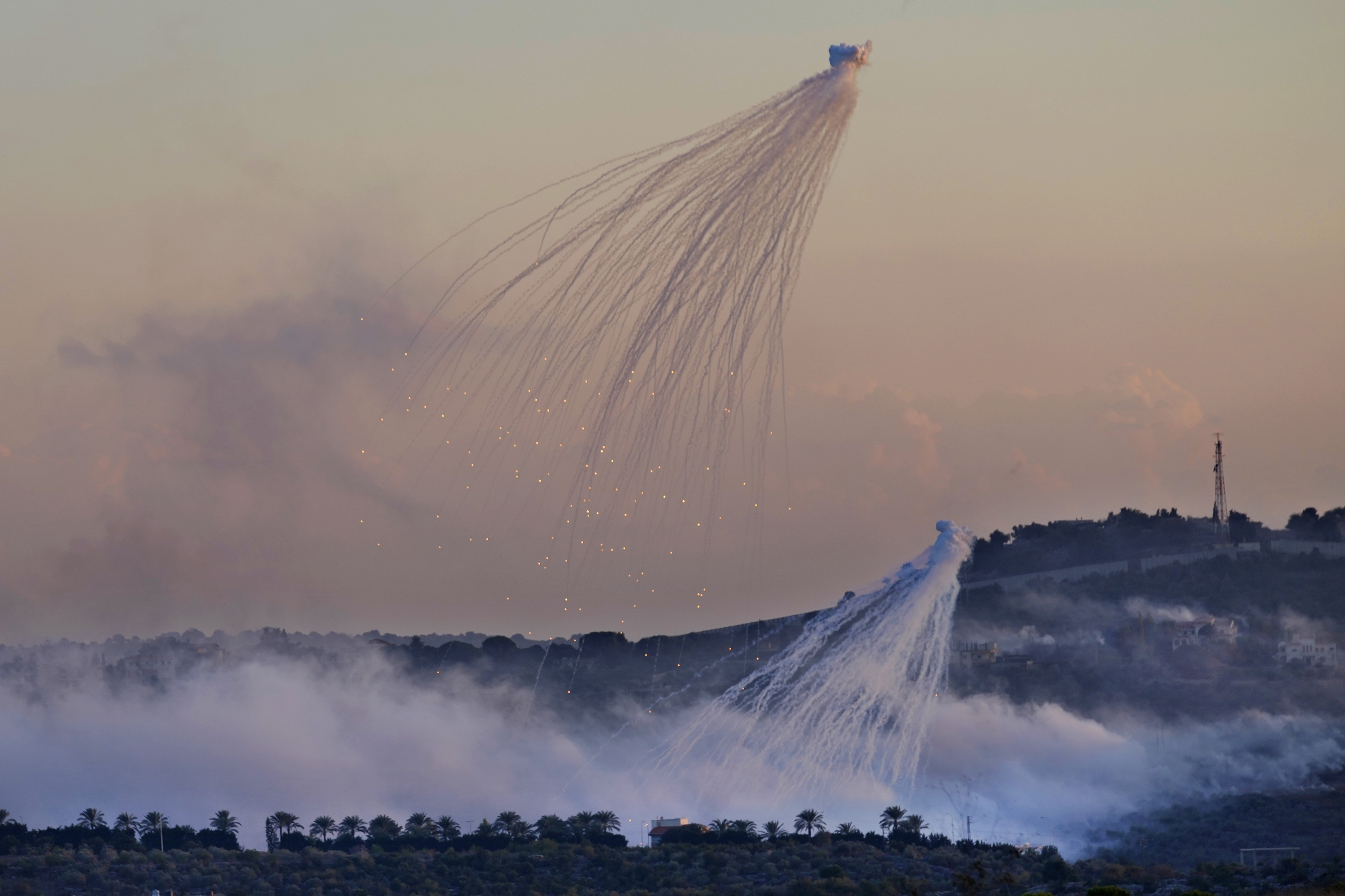 A shell from Israeli artillery explodes over Dahaira, a Lebanese border village with Israel. Photo / AP