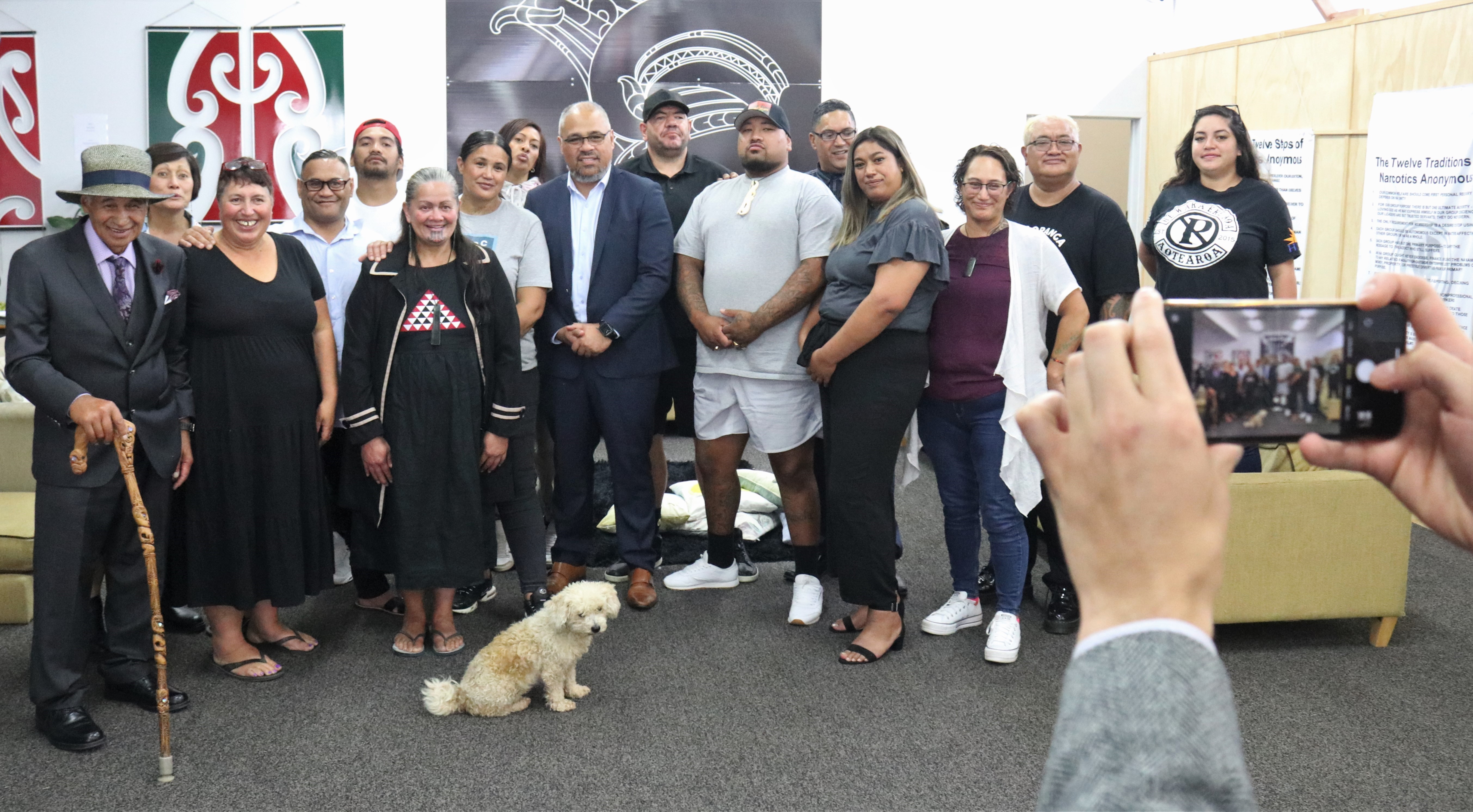 Staff and clients of Whakaoranga Whānau Recovery Hub pose for a photo with Associate Health Minister Peeni Henare. Photo / Peter de Graaf