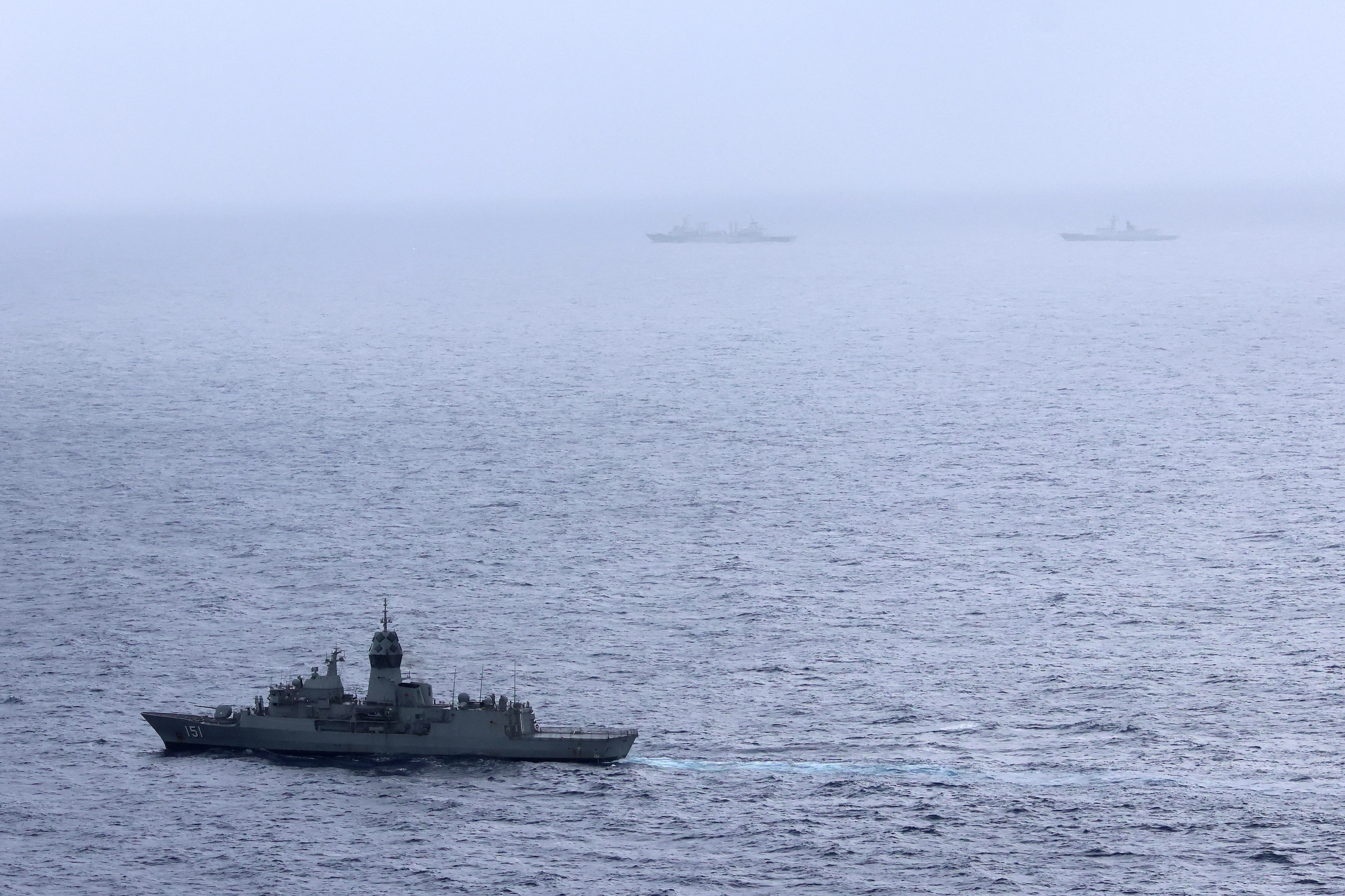 Royal Australian Navy ship HMAS Arunta (lower left) sailing near the People's Liberation Army-Navy Fuchi-class replenishment vessel and Weishanhu Jiangkai-class frigate Hengyang in the Tasman Sea. Photo / AFP