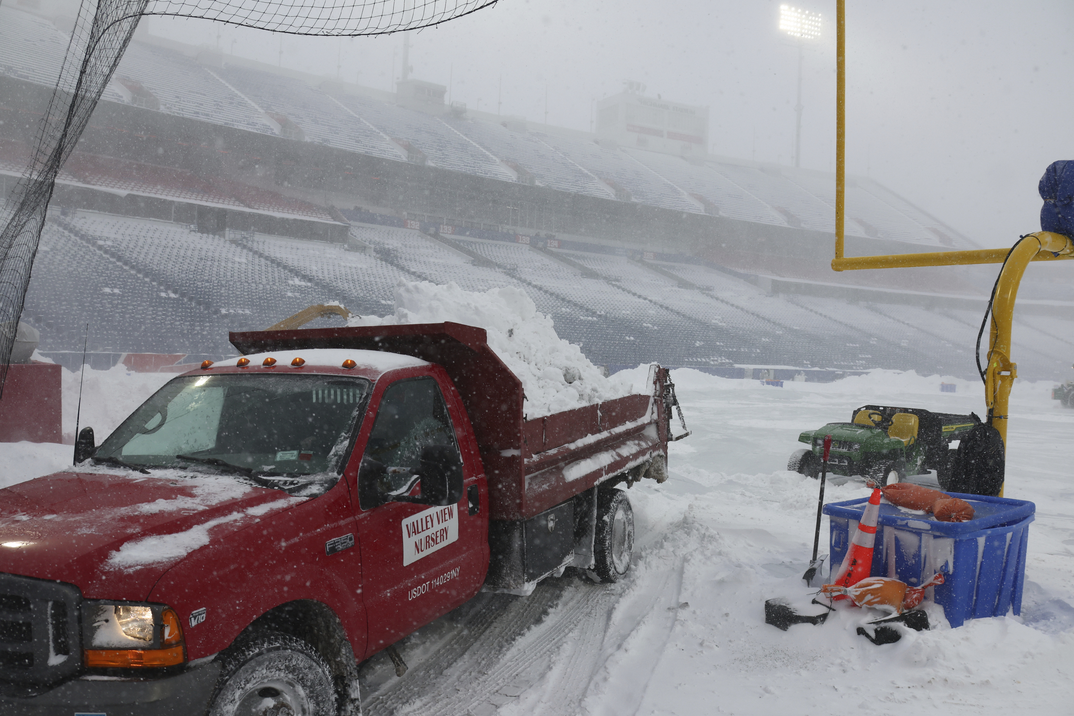 Workers remove snow from Highmark Stadium for the Steelers v Bills game. Photo / AP