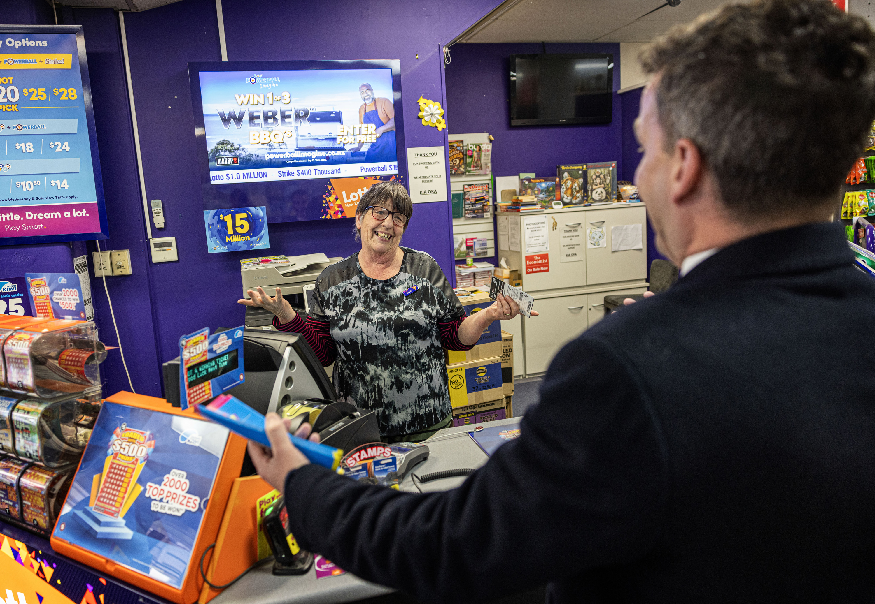 While hitting the streets, Seymour bought a scratchie from Mainly Magazines and Lotto owner Wendy Marshall. Photo / Mike Scott.