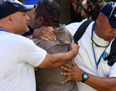One of the protesters led away after the attack on John Key. Photo / Michael Cunningham