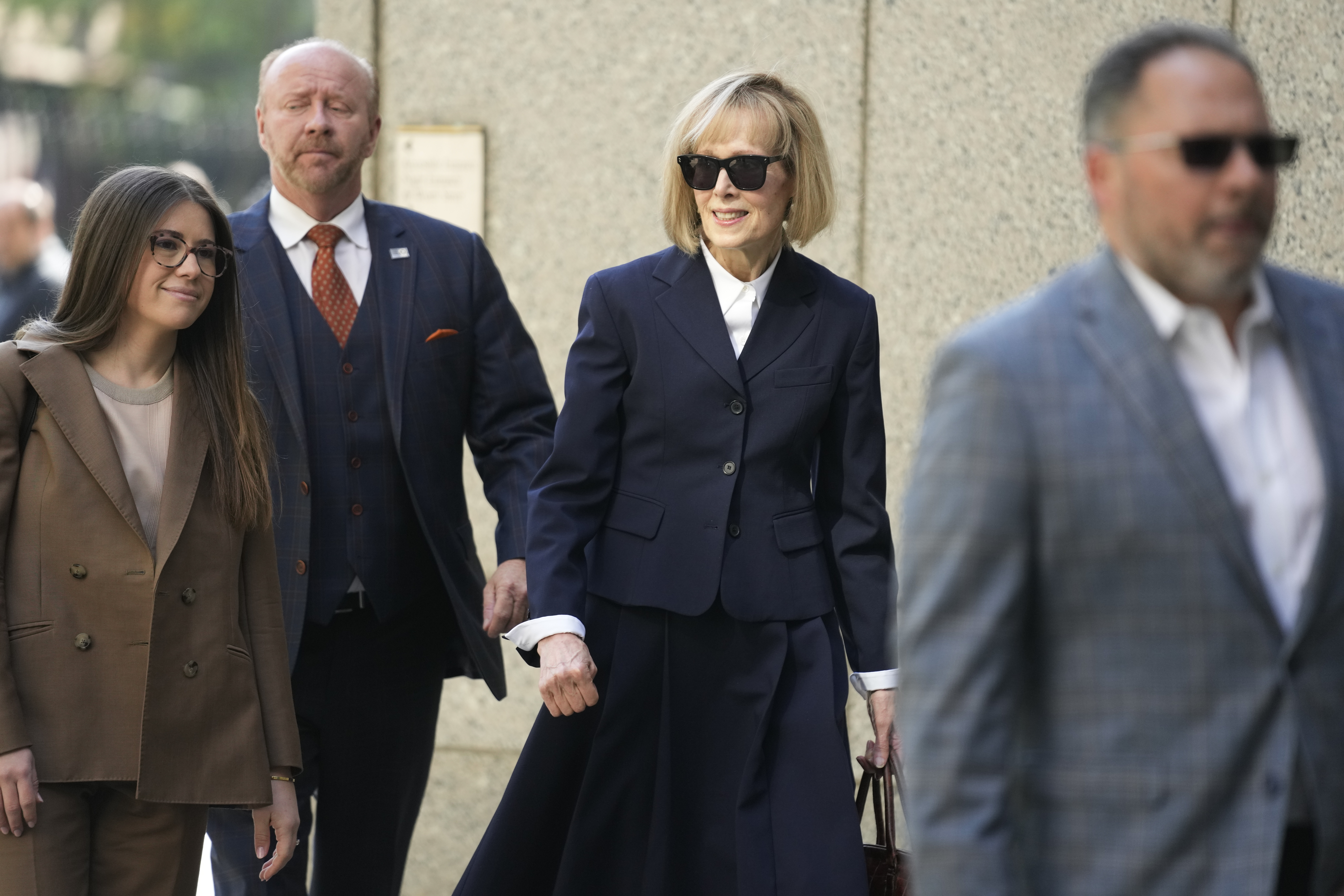 Former advice columnist E. Jean Carroll (second from right) arrives at federal court. Photo / AP