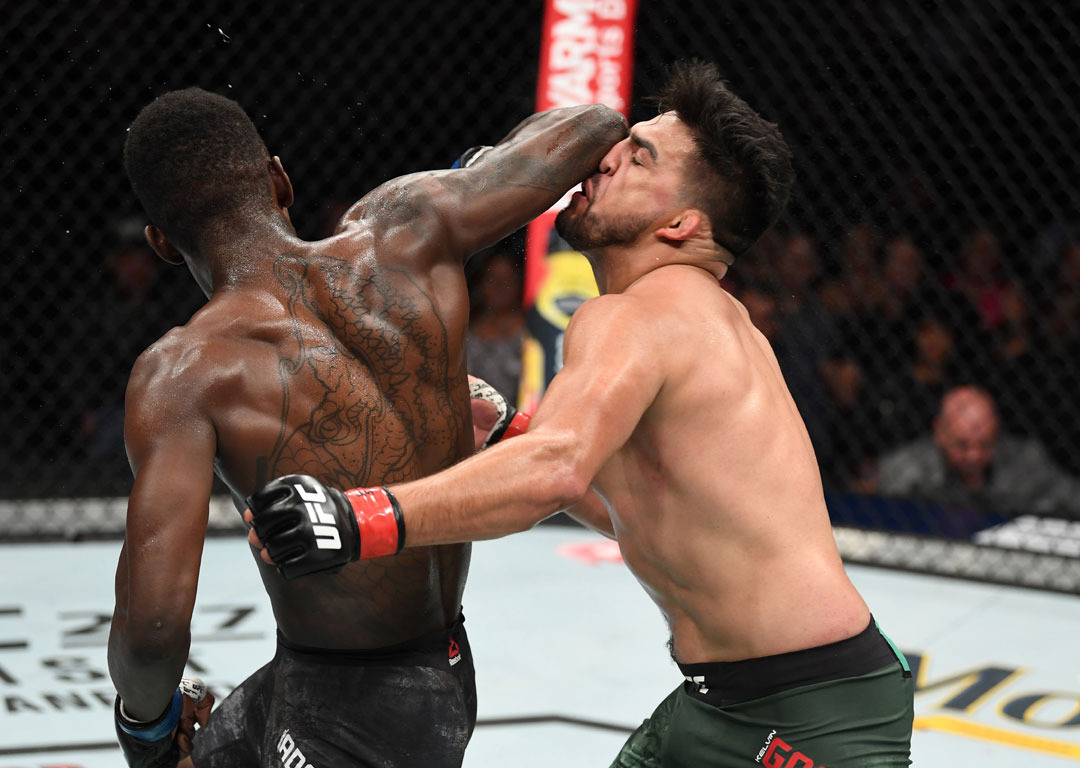  Israel Adesanya lands a spinning reverse elbow against Kelvin Gastelum. Photo / Getty