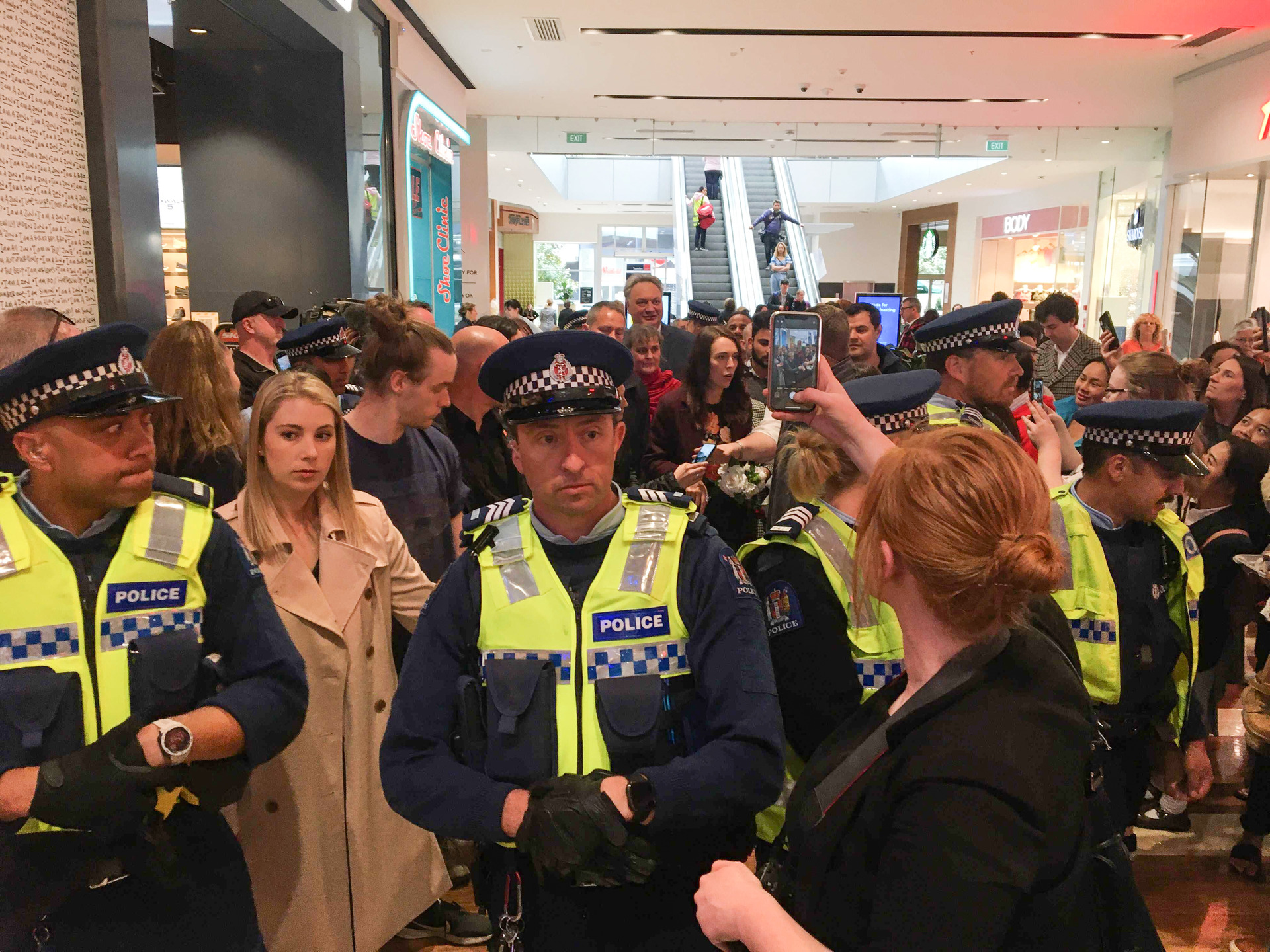 Police make a circle around Prime Minister Jacinda Ardern at Westfield Riccarton. Photo / Claire Trevett