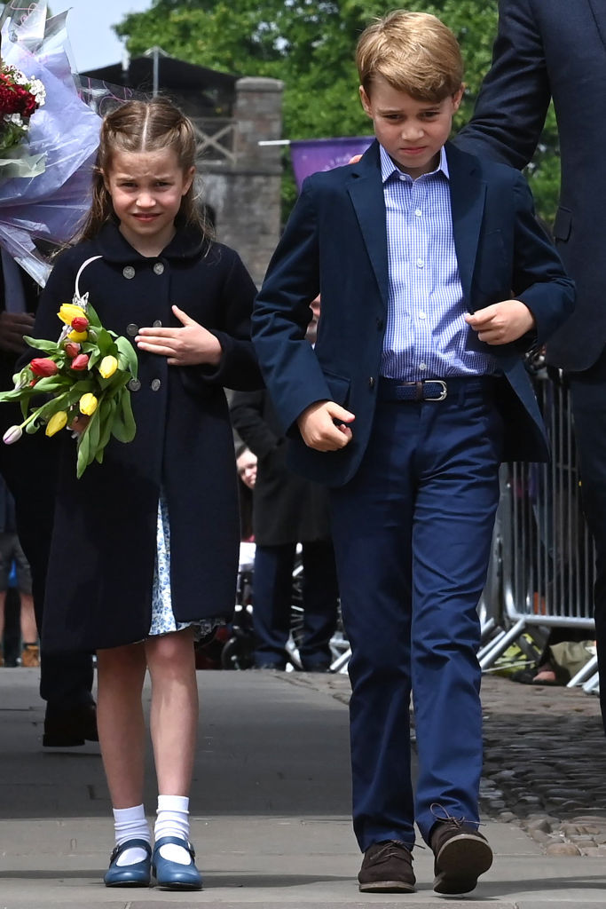 Charlotte and big brother George make their way past crowds in Wales. Photo / Getty Images