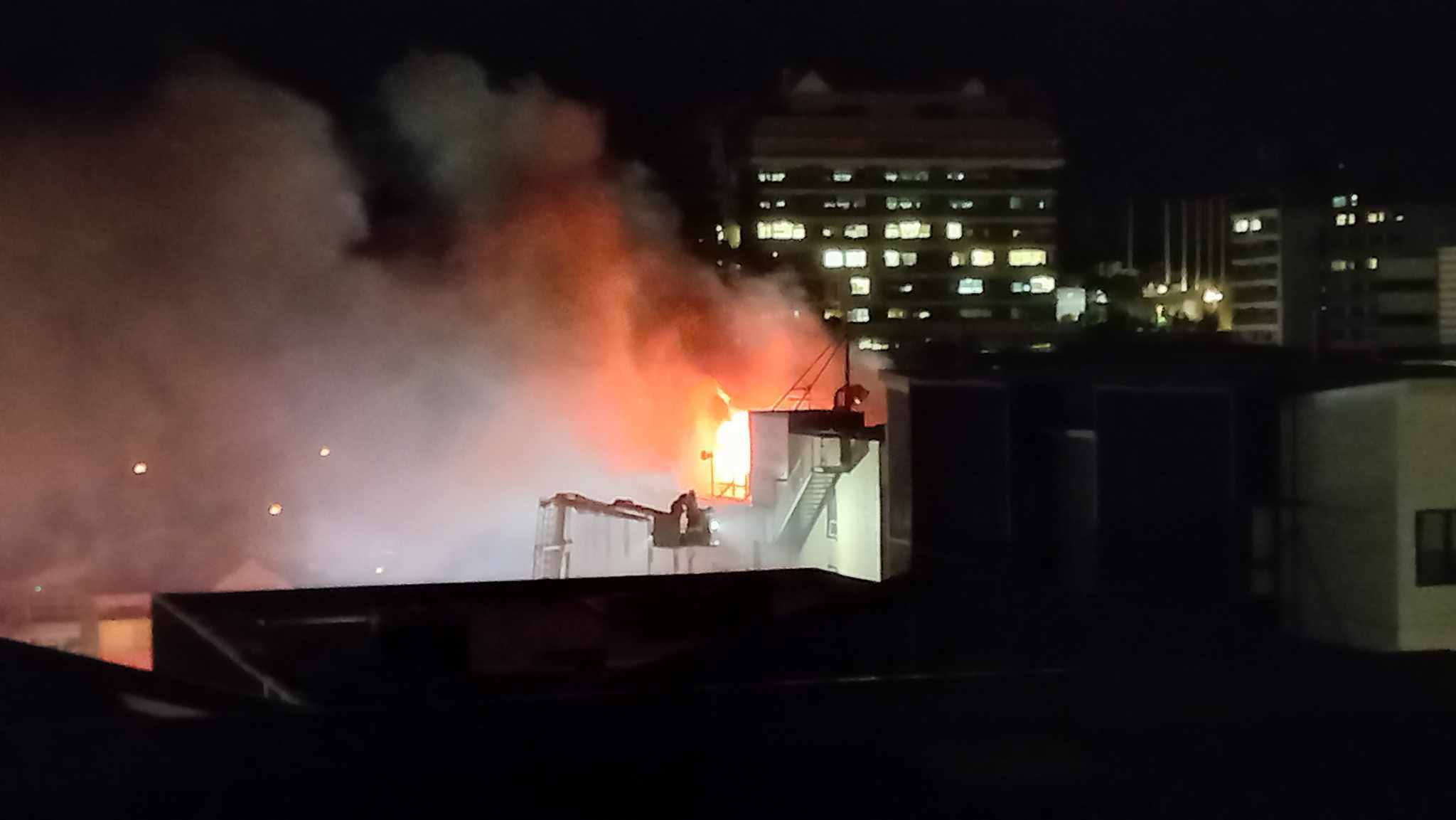 Flames were seen shooting from Loafers Lodge in Wellington after a fatal fire on Tuesday. Photo / Sunnie Chan