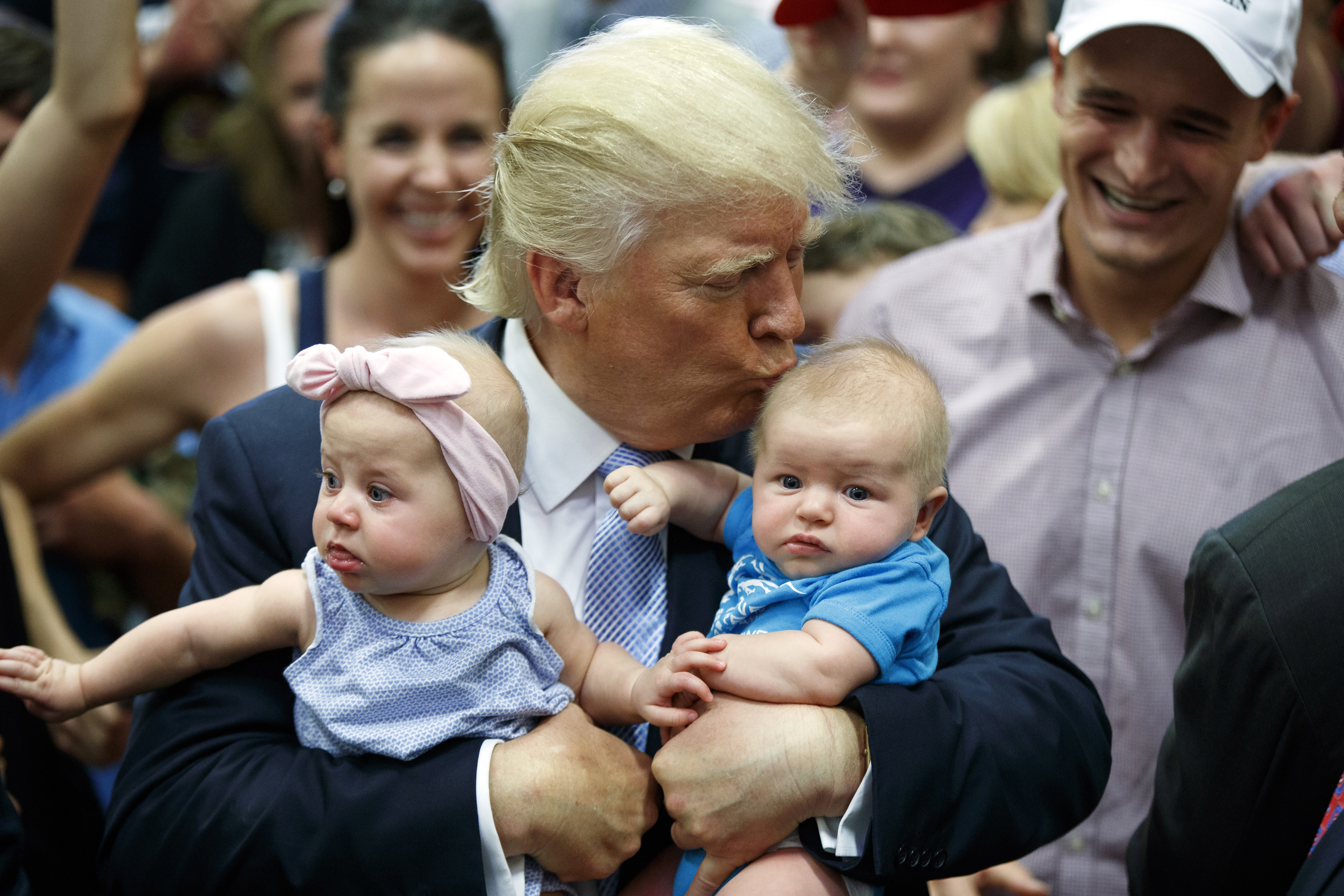 Donald Trump kissing baby Kellen Campbell of Denver, while also holding Evelyn Keane of Castle Rock, Colorado. Photo / AP
