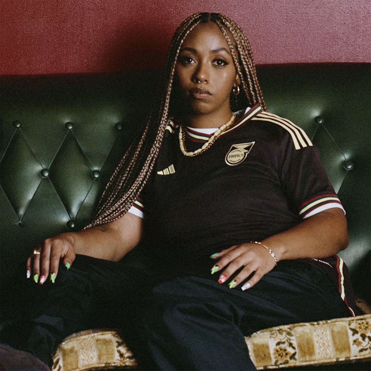 Layered necklaces and black trousers make the Jamaica away kit compulsively wearable. Photo / Adidas