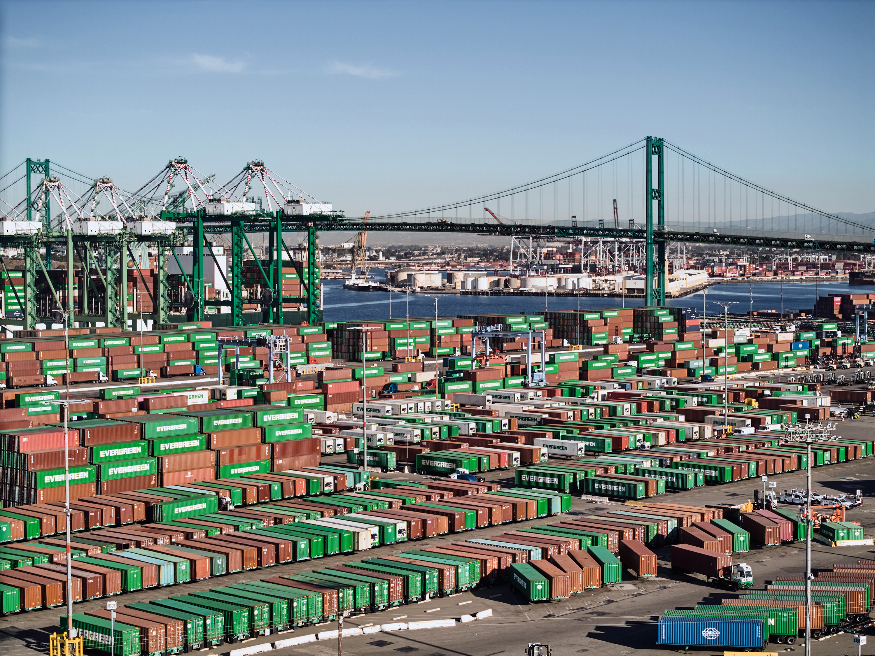 The Vincent Thomas Bridge looms over cargo containers at the Port of Los Angeles on Nov. 1, 2023. Most economists expect fresh trade barriers to raise prices for US businesses and households, which could lead to a temporary burst of higher inflation. Photo / Adam Amengual, The New York Times