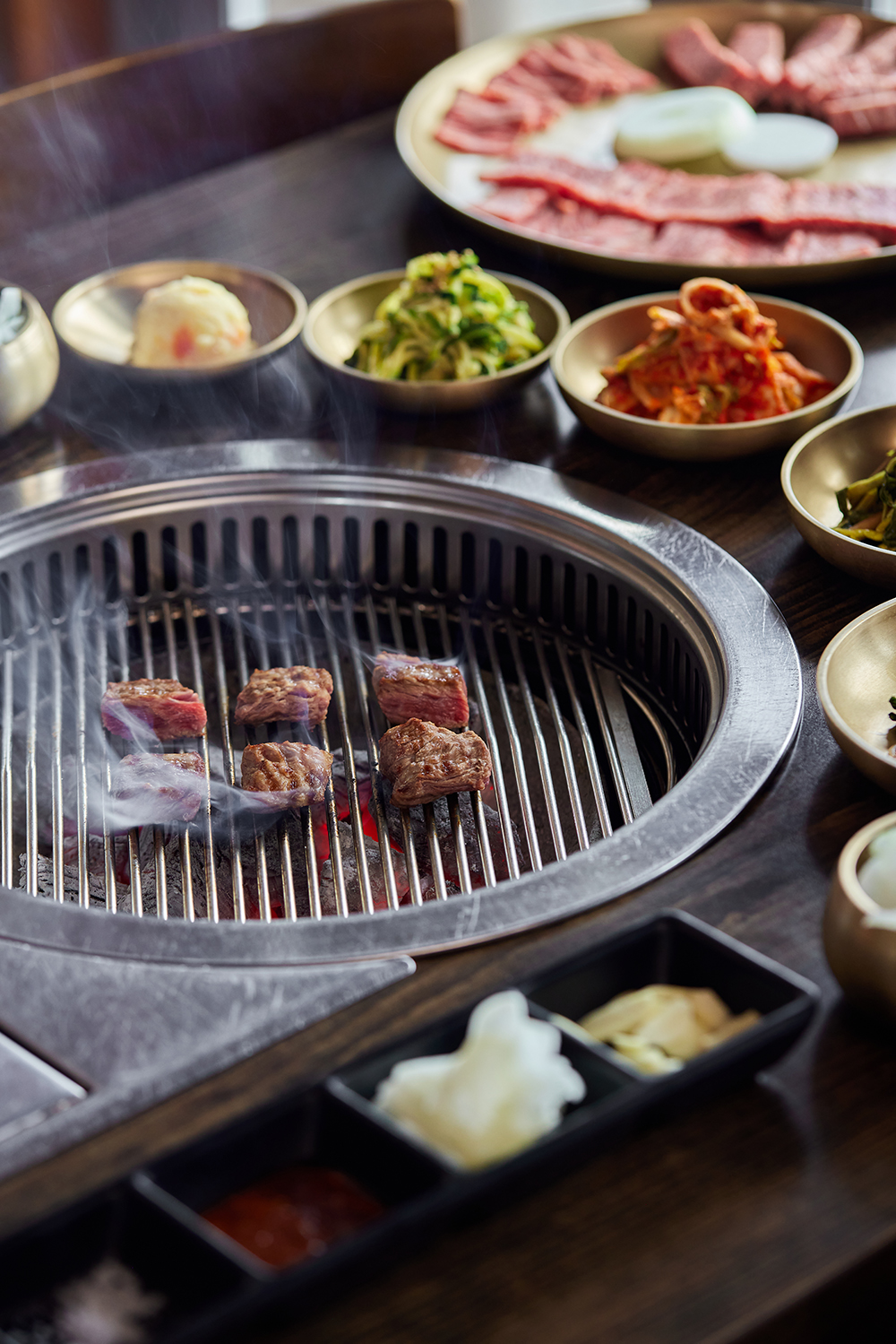 Enjoy pork and beef cuts of your choice, which you grill and turn over a bowl of hot coals. Photo / Babiche Martens