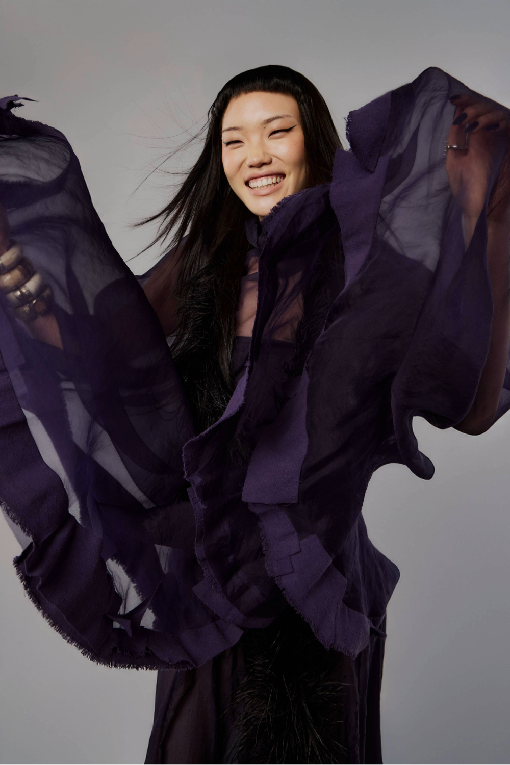 Sophie Song wears cape and gown by Giulia Zigliani, feather boa and bracelets from Tango, Earrings by Niicolé Polard and shoes by Stolen Girlfriends Club. Photo / Mara Sommer for New Zealand Fashion Week.
