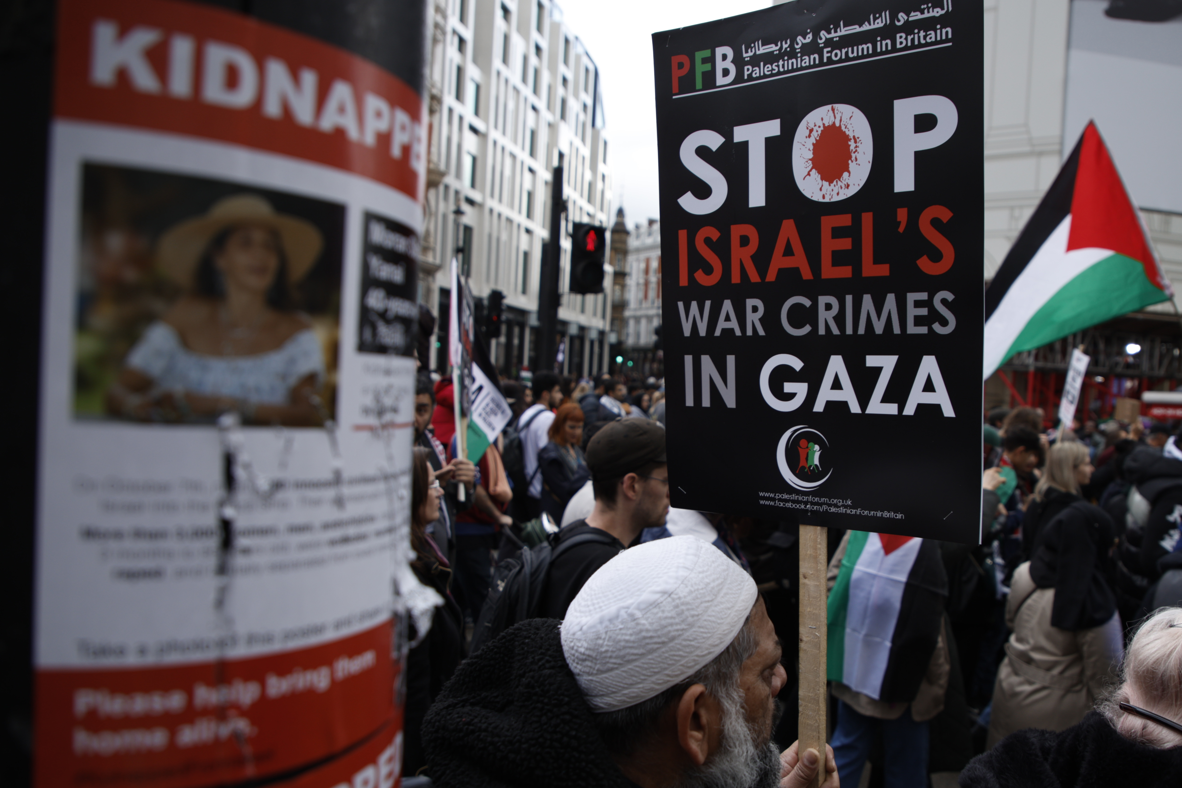 A damaged poster on a lamppost shows an image of Israeli citizens who have allegedly been kidnapped by the militant group Hamas, pictured during a pro-Palestinian demonstration in London. Photo / AP