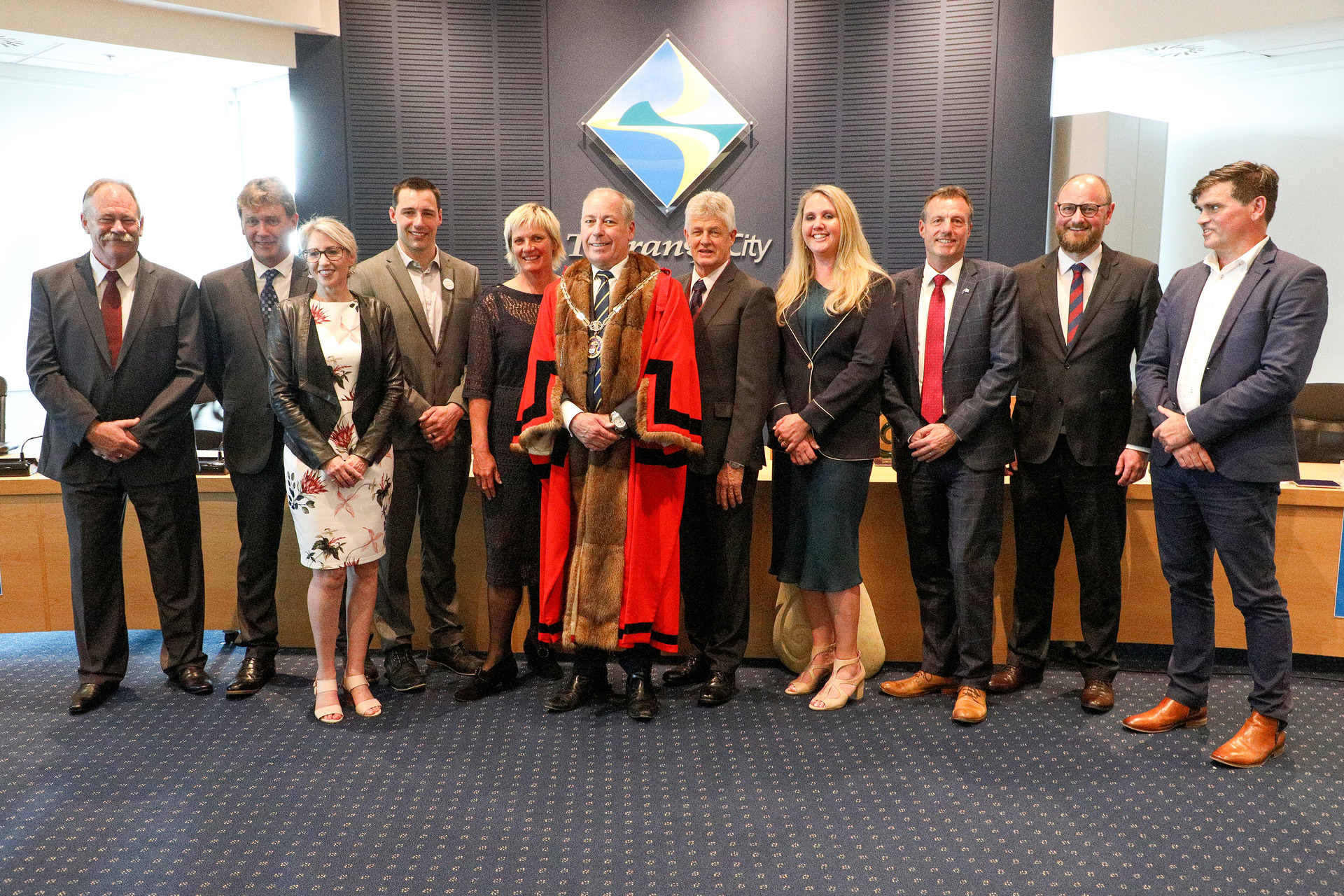 Tauranga City Council after elected members were sworn in last year. Mayor Tenby Powell, in red, and Councillor Jako Abrie, fourth from left, have since resigned. Photo / File