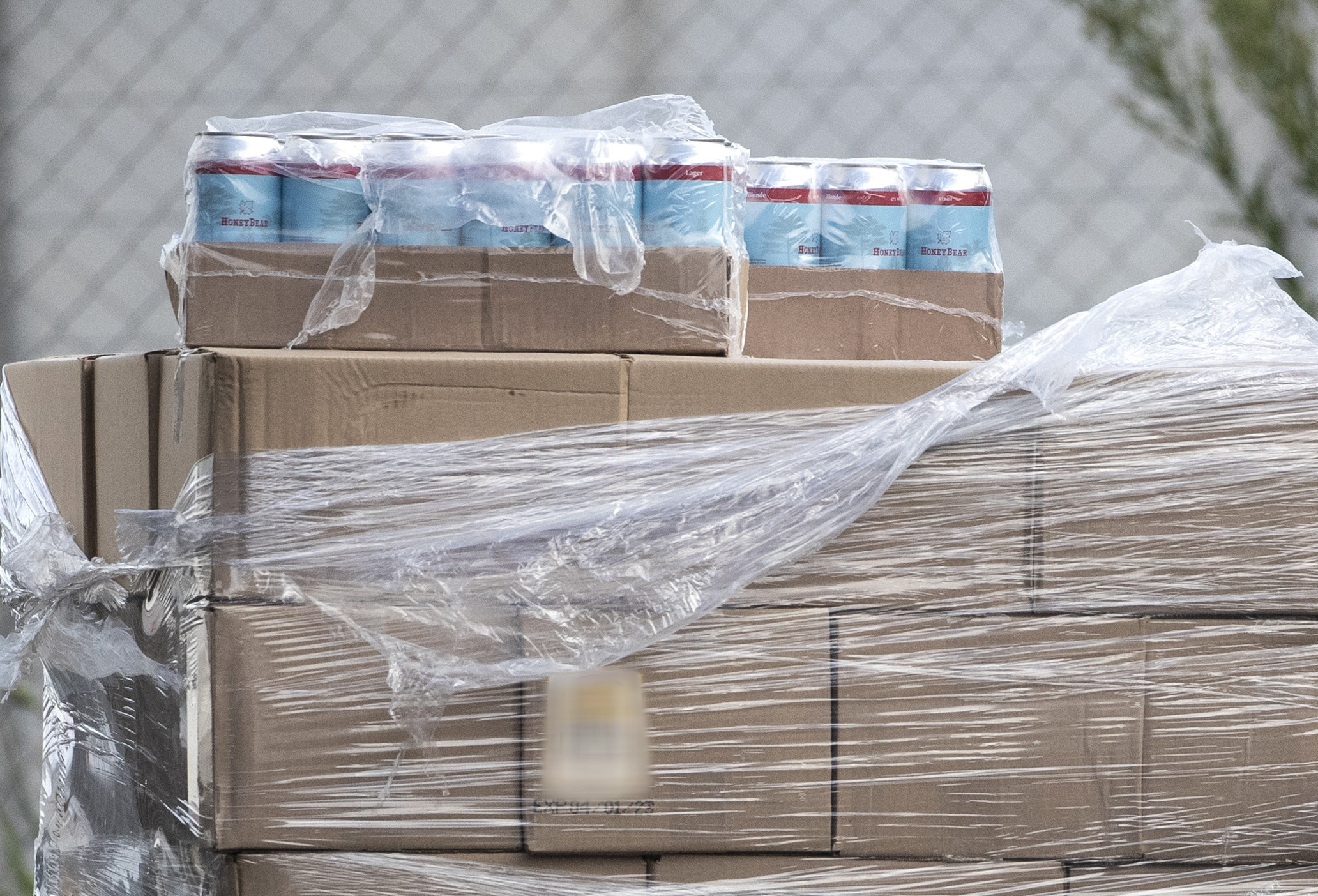 Police seized a number of pallets containing Honey Bear House Beer from a warehouse in Manukau, Auckland. Photo / Jason Oxenham