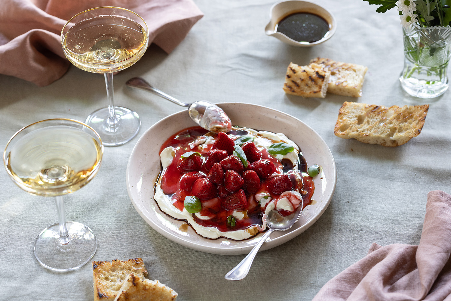 Strawberries, labneh and balsamic drizzle is a sweet and showstopping dessert. Photo / Babiche Martens