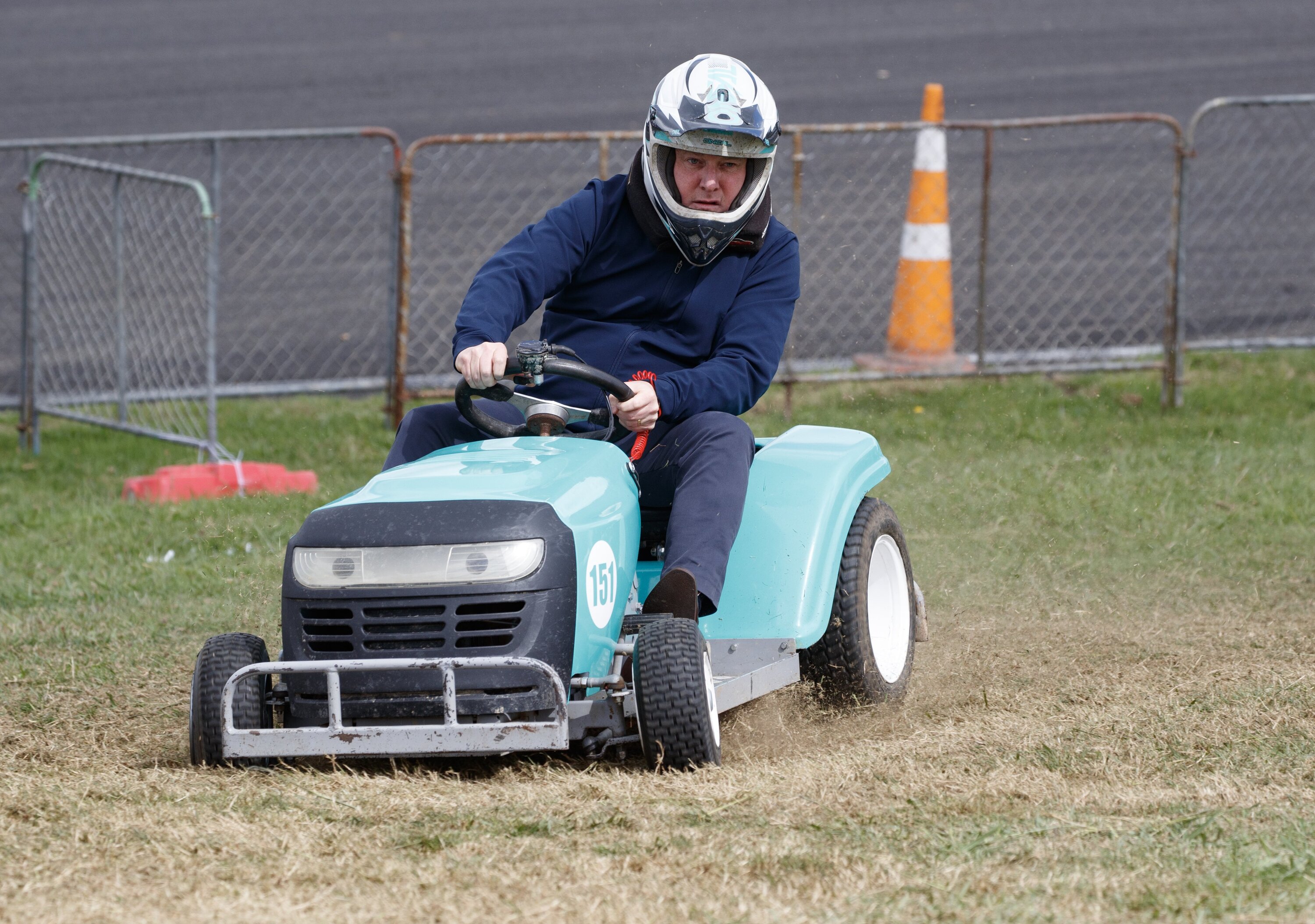 Prime Minister Christopher Luxon racing a ride-on lawnmower during his visit to the Central Districts Field Days at Manfeild on Thursday. Photo / Mark Mitchell