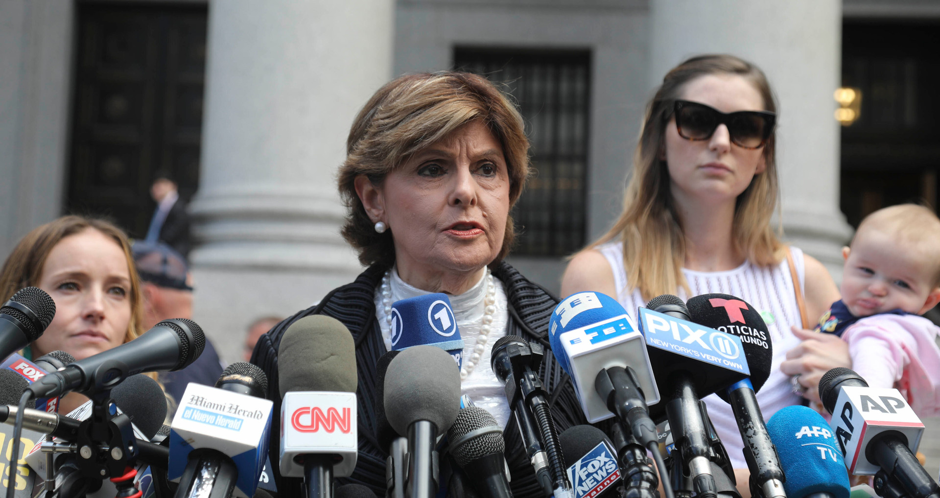 Attorney Gloria Allred, centre, flanked by two of her clients, speaks during a news conference after leaving a Manhattan court where sexual victims addressed a hearing. Photo / AP