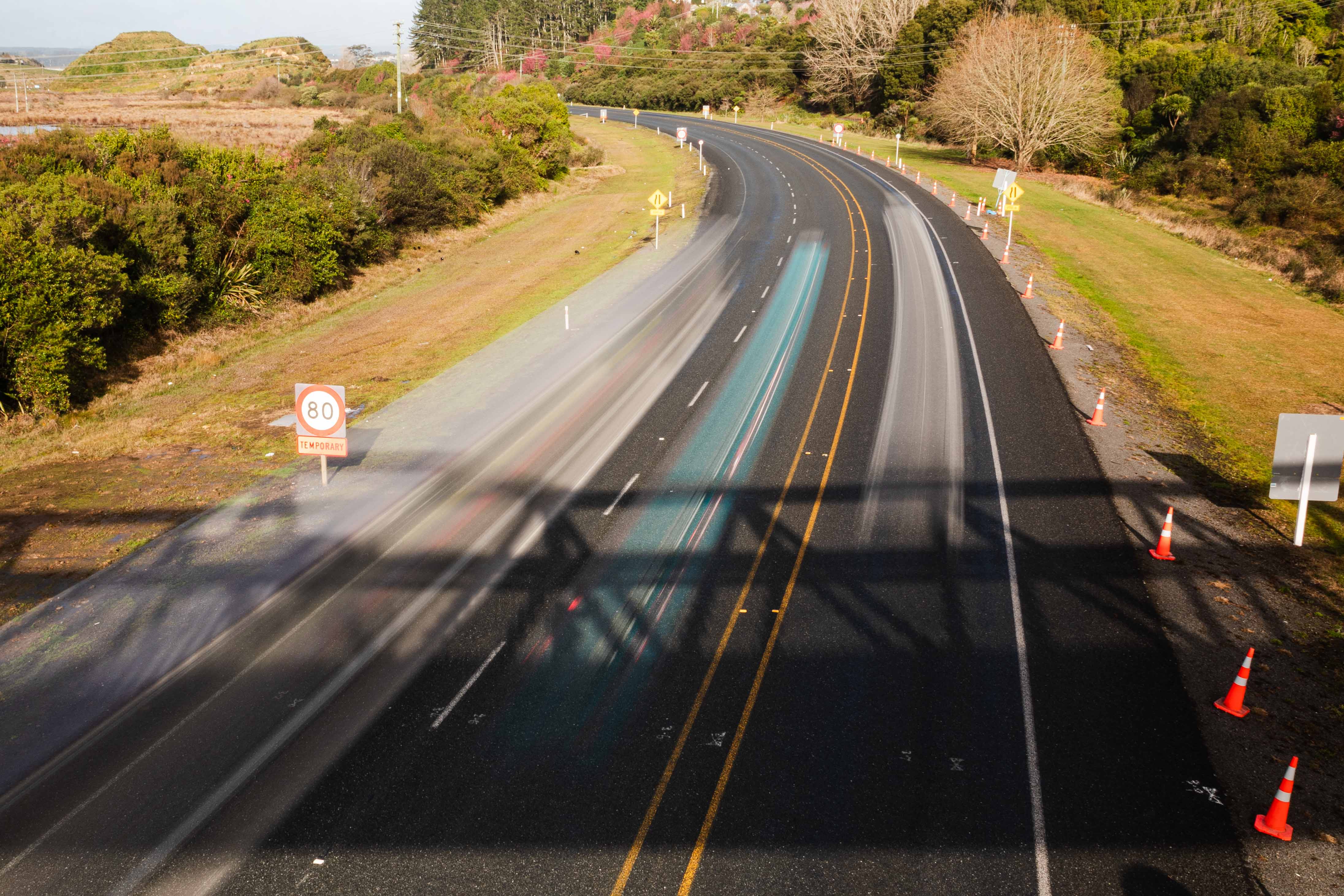 Traffic whizzes along the Takitimu Drive toll road, looking towards the Lakes. Photo / Alex Cairns